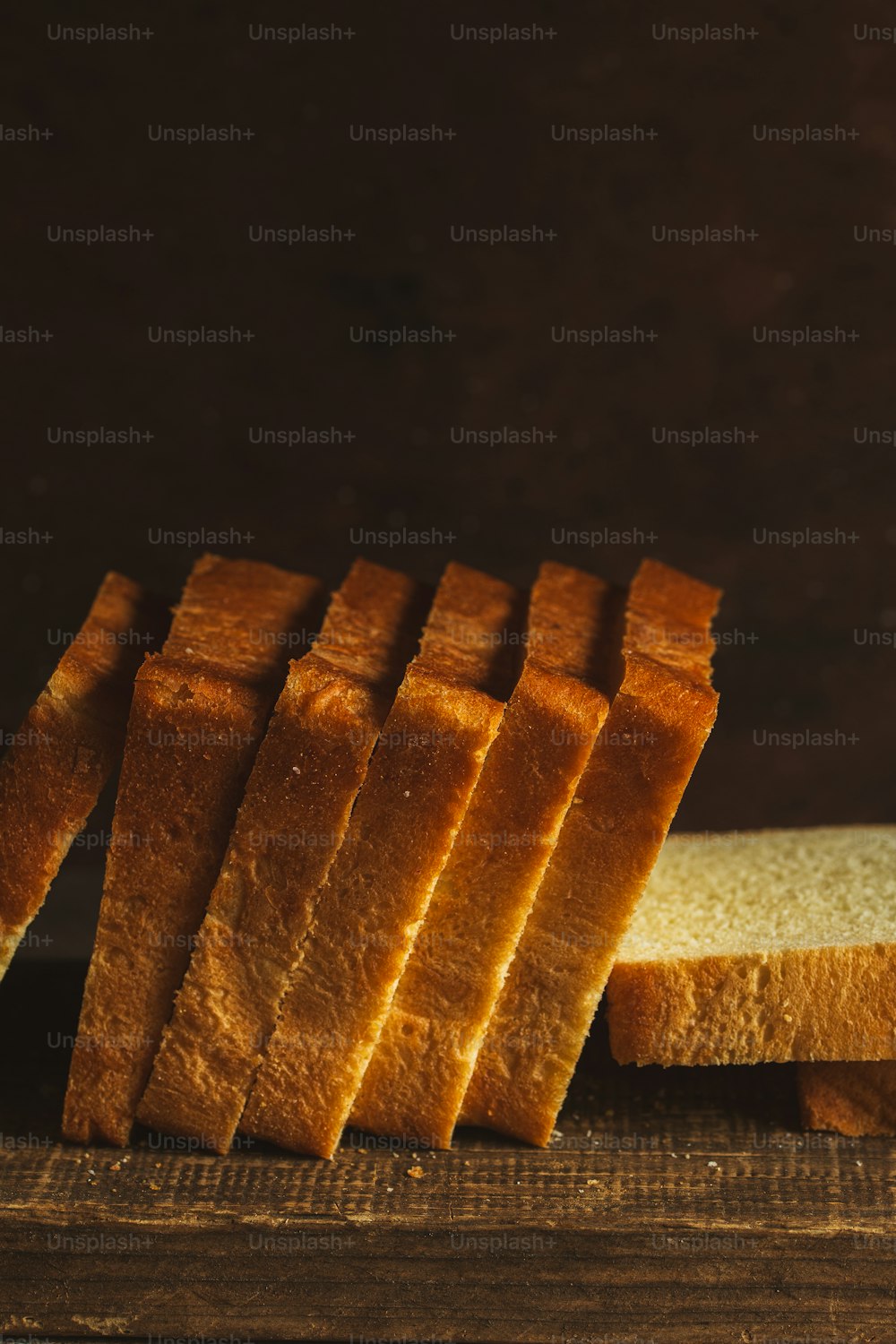 a sliced loaf of bread sitting on top of a wooden table