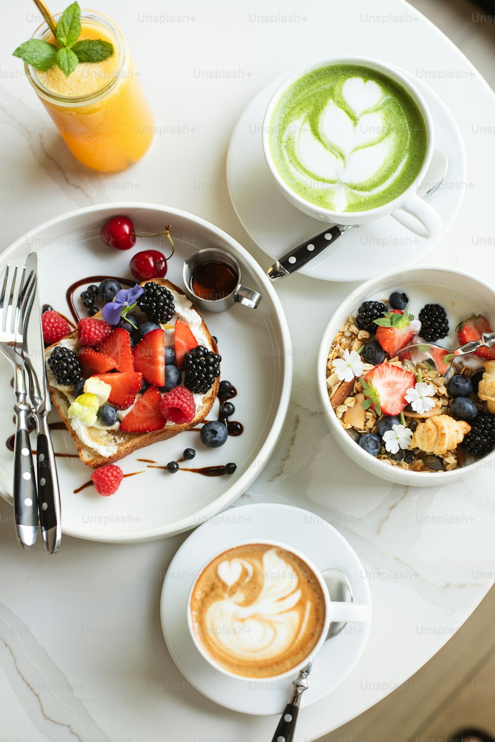 a table topped with two plates of food and a cup of coffee