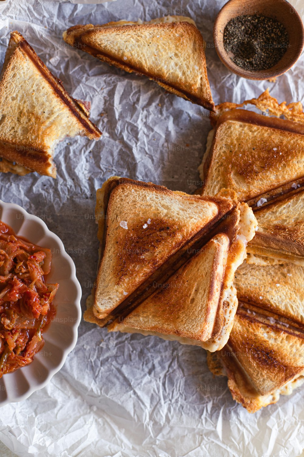 toasted sandwiches and a bowl of chili on a table