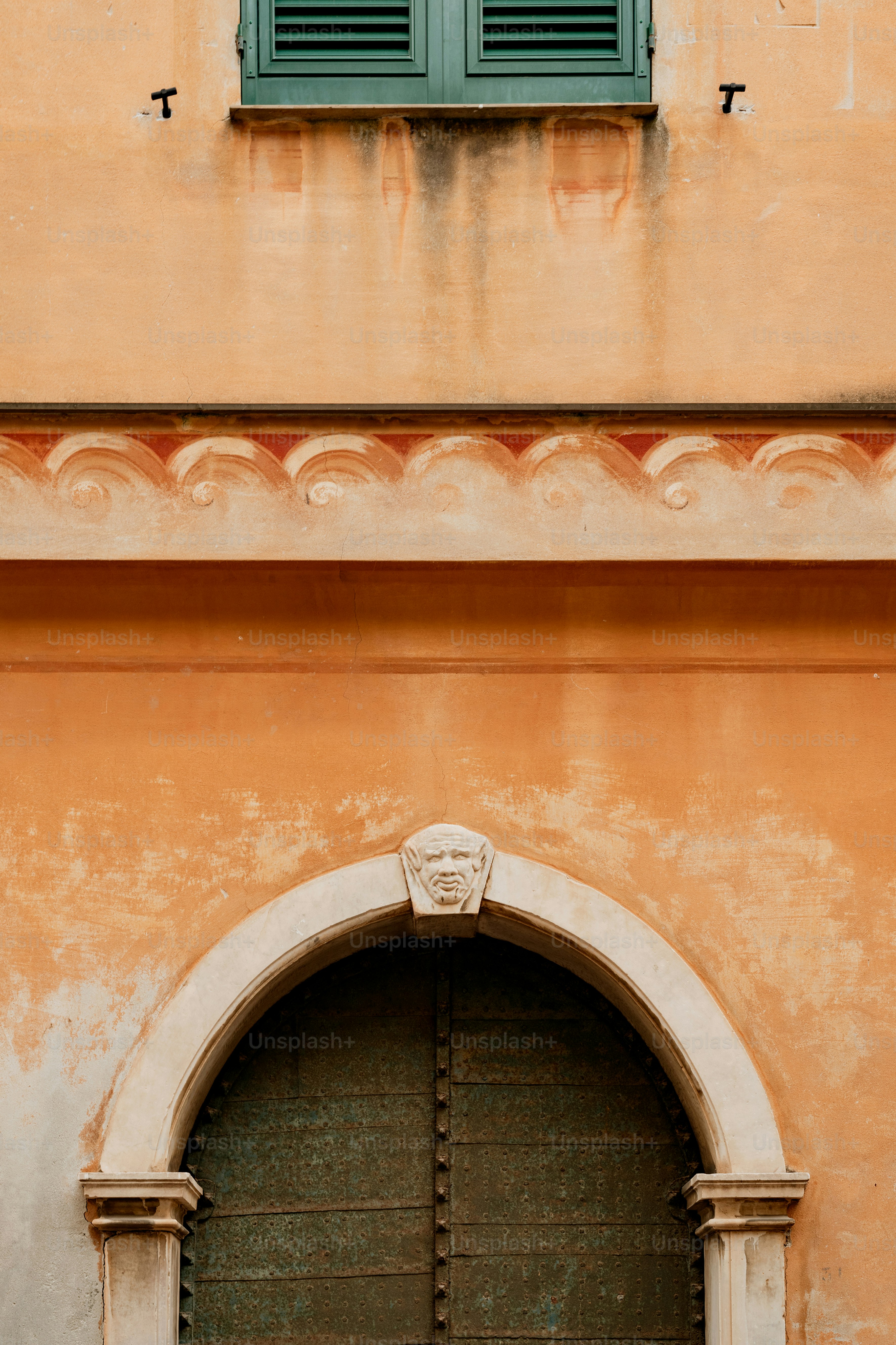 a building with a green door and a green window