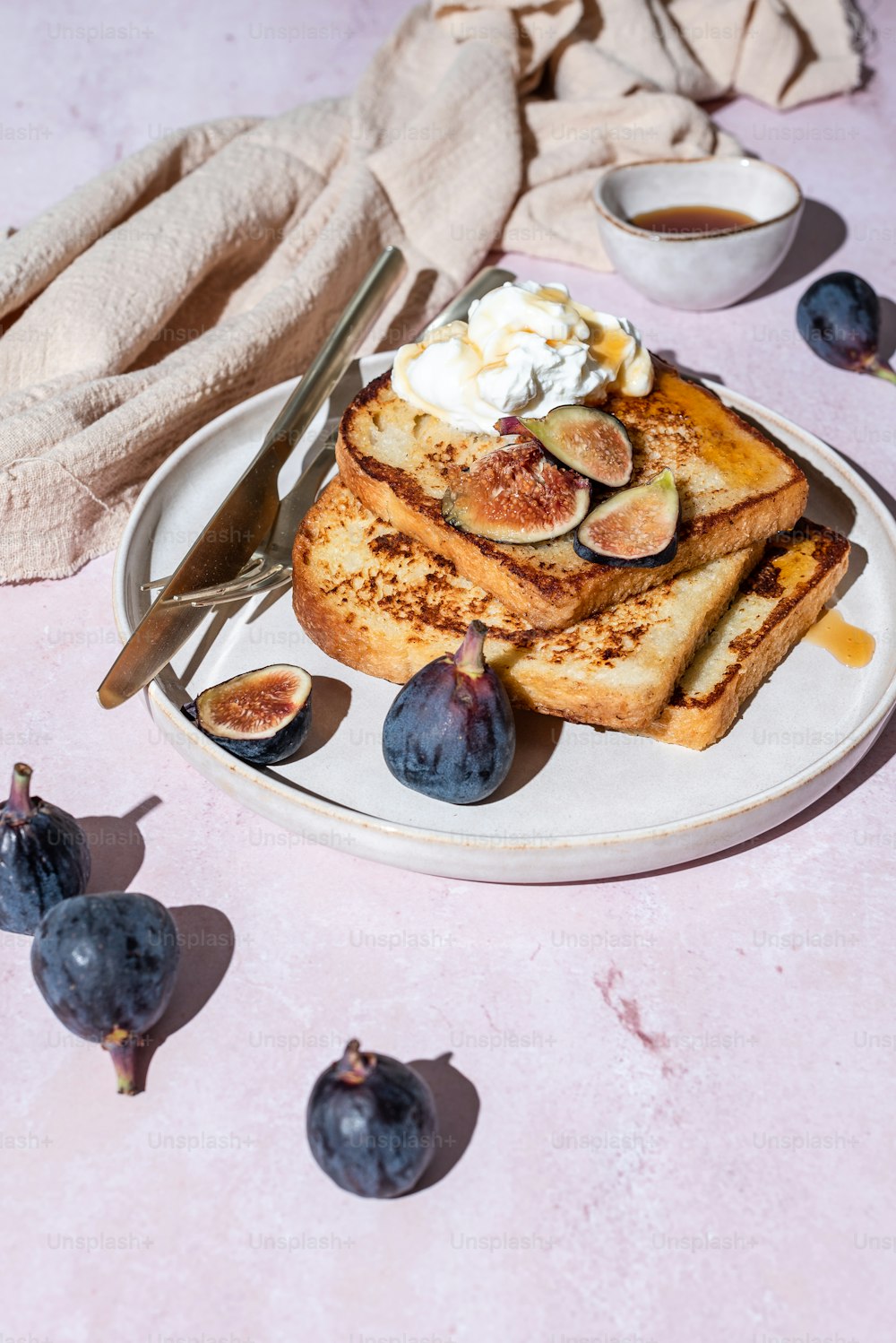 a white plate topped with french toast and figs