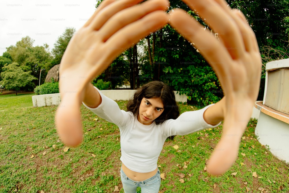 a woman holding her hands up in the air