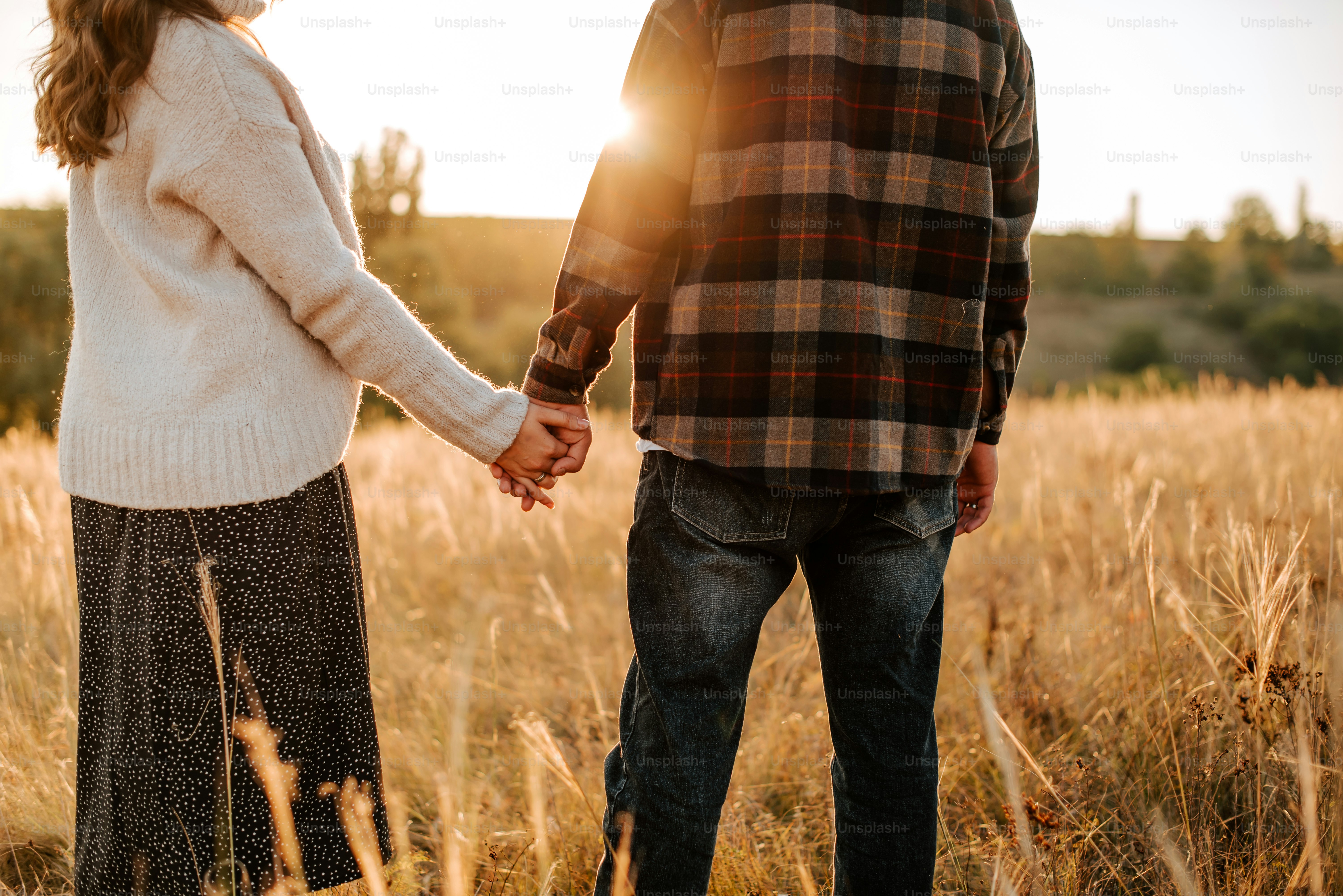 A man and a woman holding hands in a field photo – Lifestyle Image on ...
