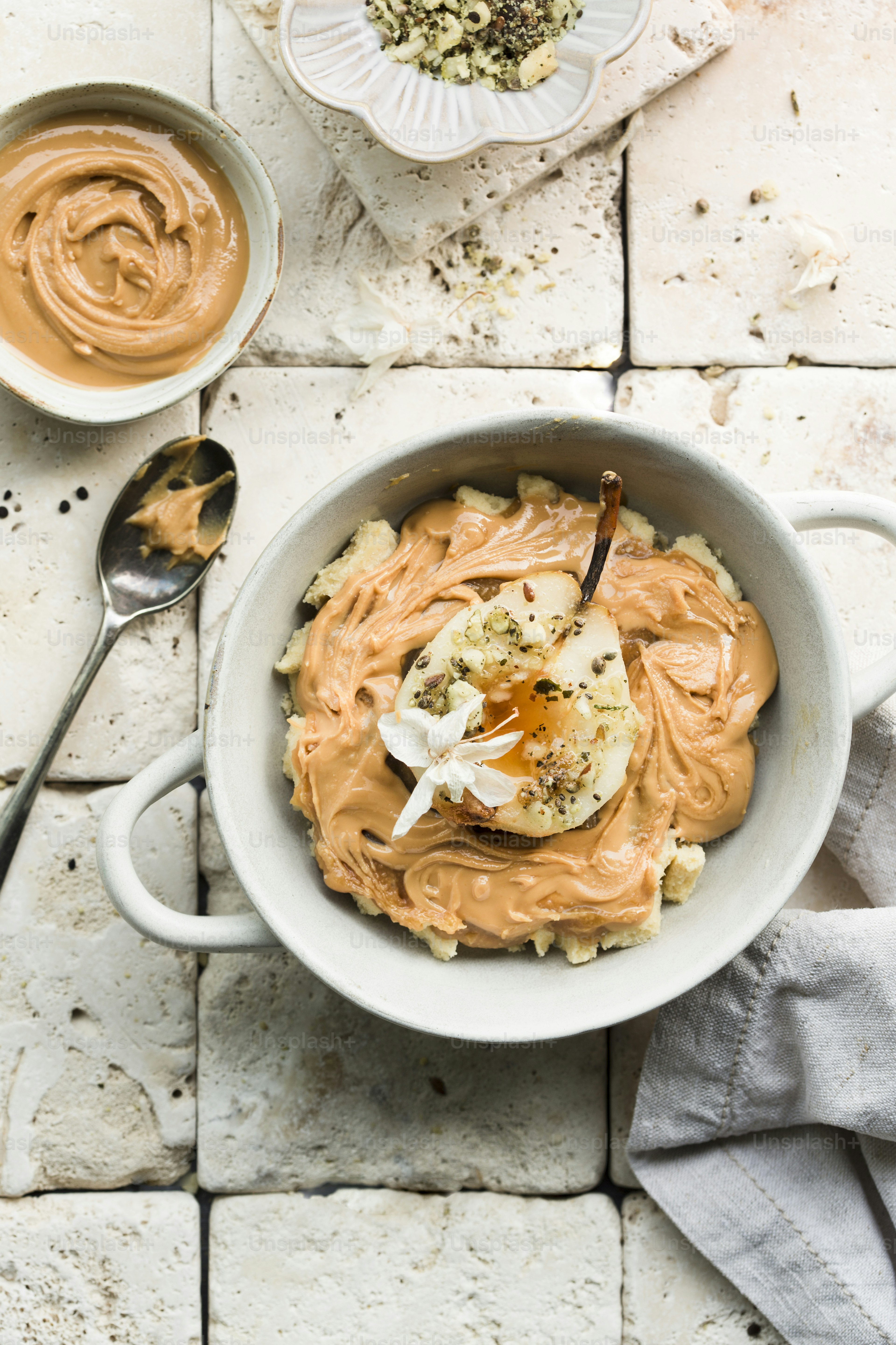 a bowl of hummus with a spoon next to it