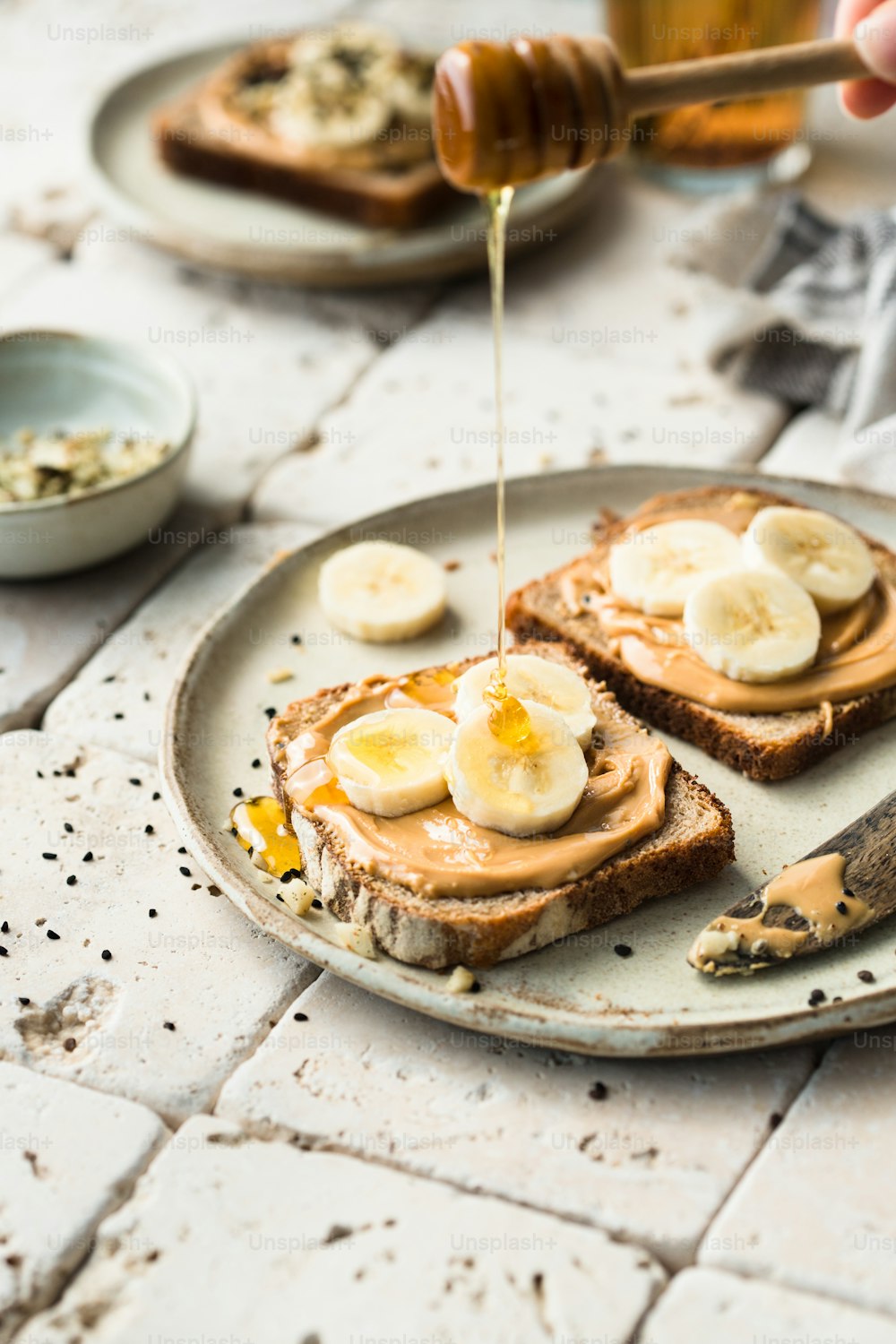 a plate of toast with peanut butter and banana slices