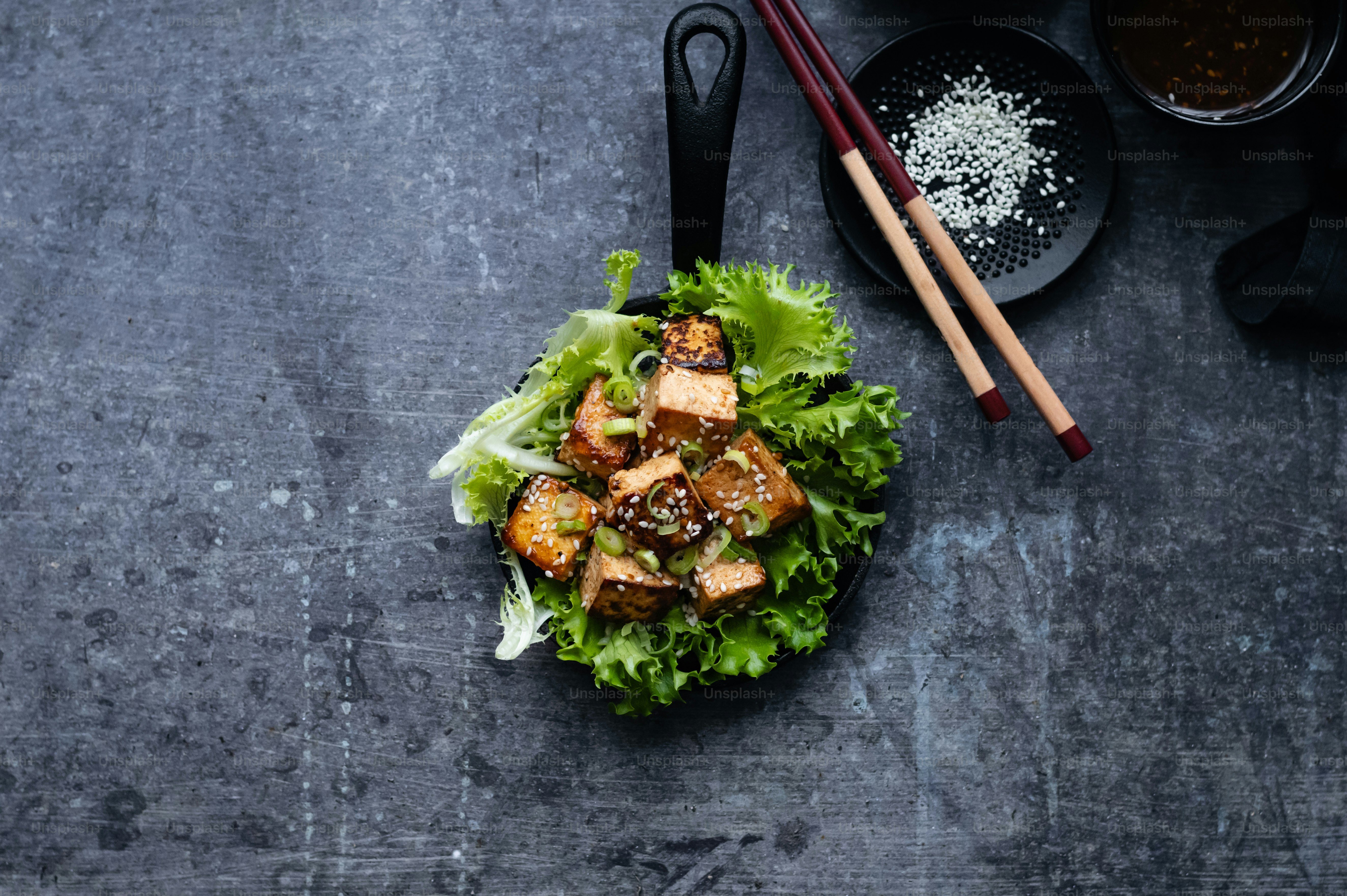 a plate of food on a table with chopsticks