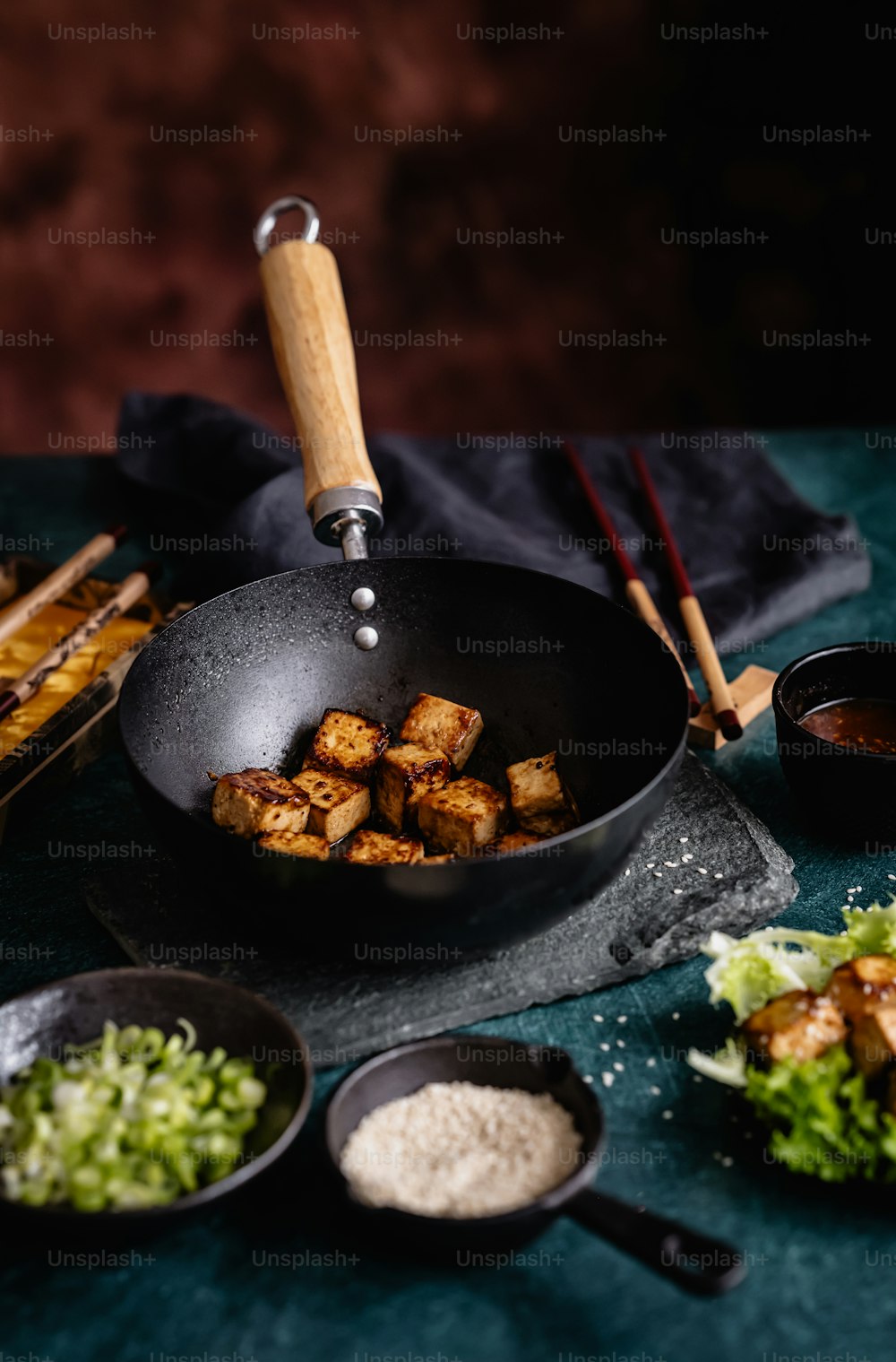 a frying pan filled with tofu and vegetables