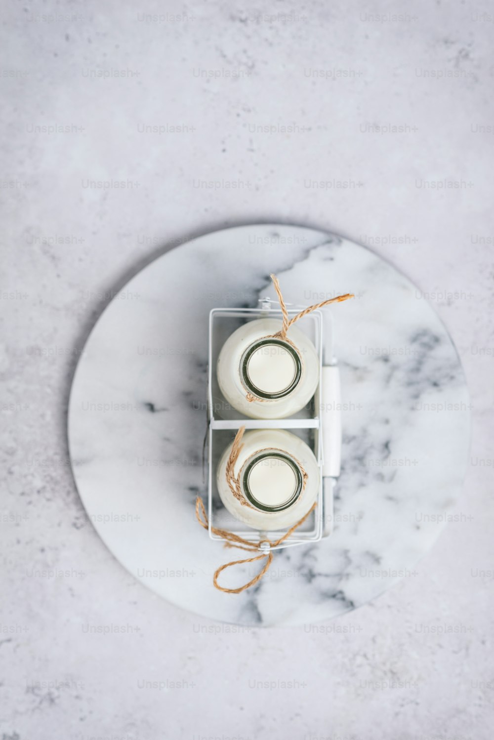 two candles in a box on a marble plate
