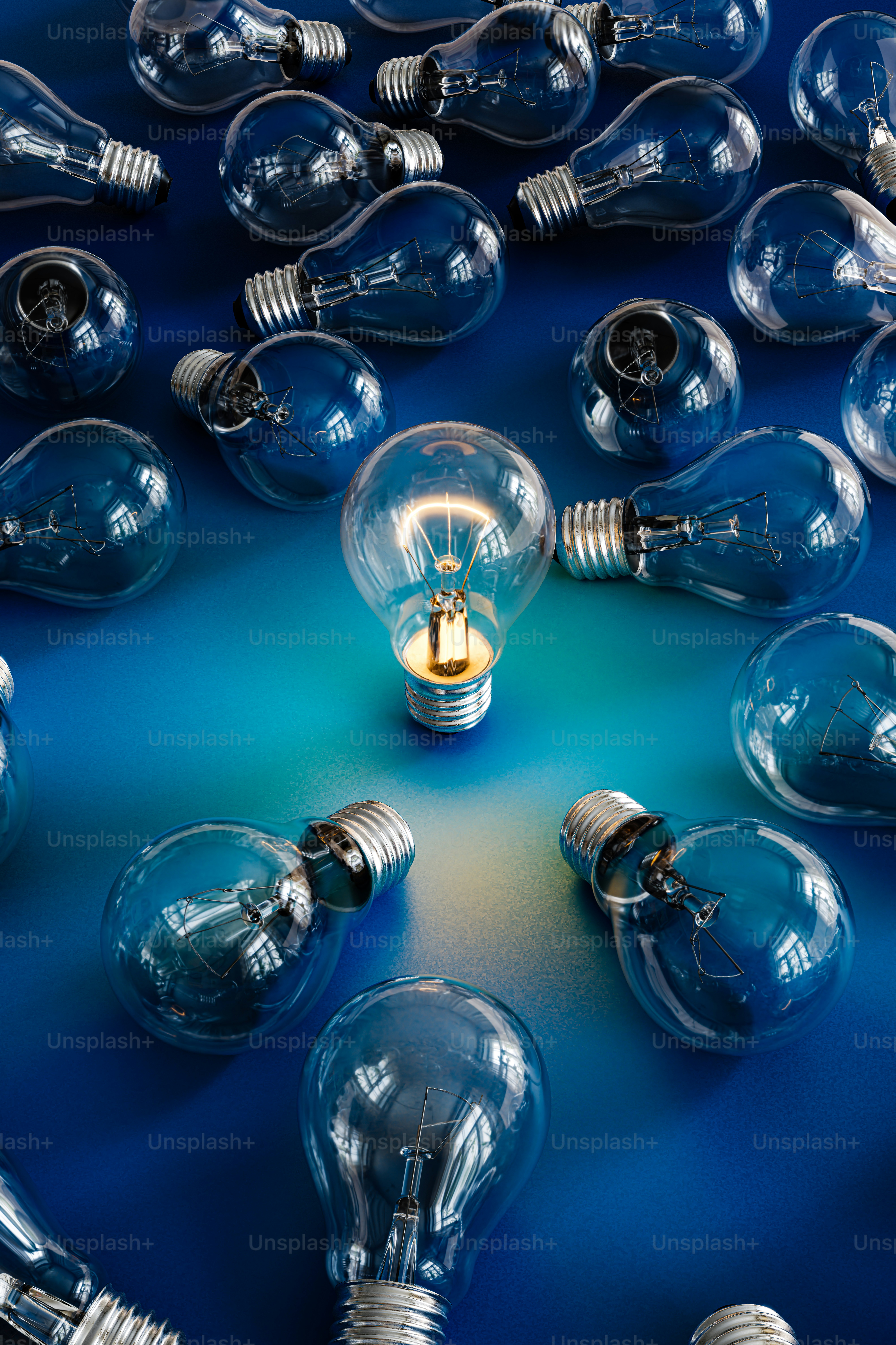 3D render visualizing a glowing light bulb in a pile of faded light bulbs as a unique idea among a stream of ordinary and boring ideas.