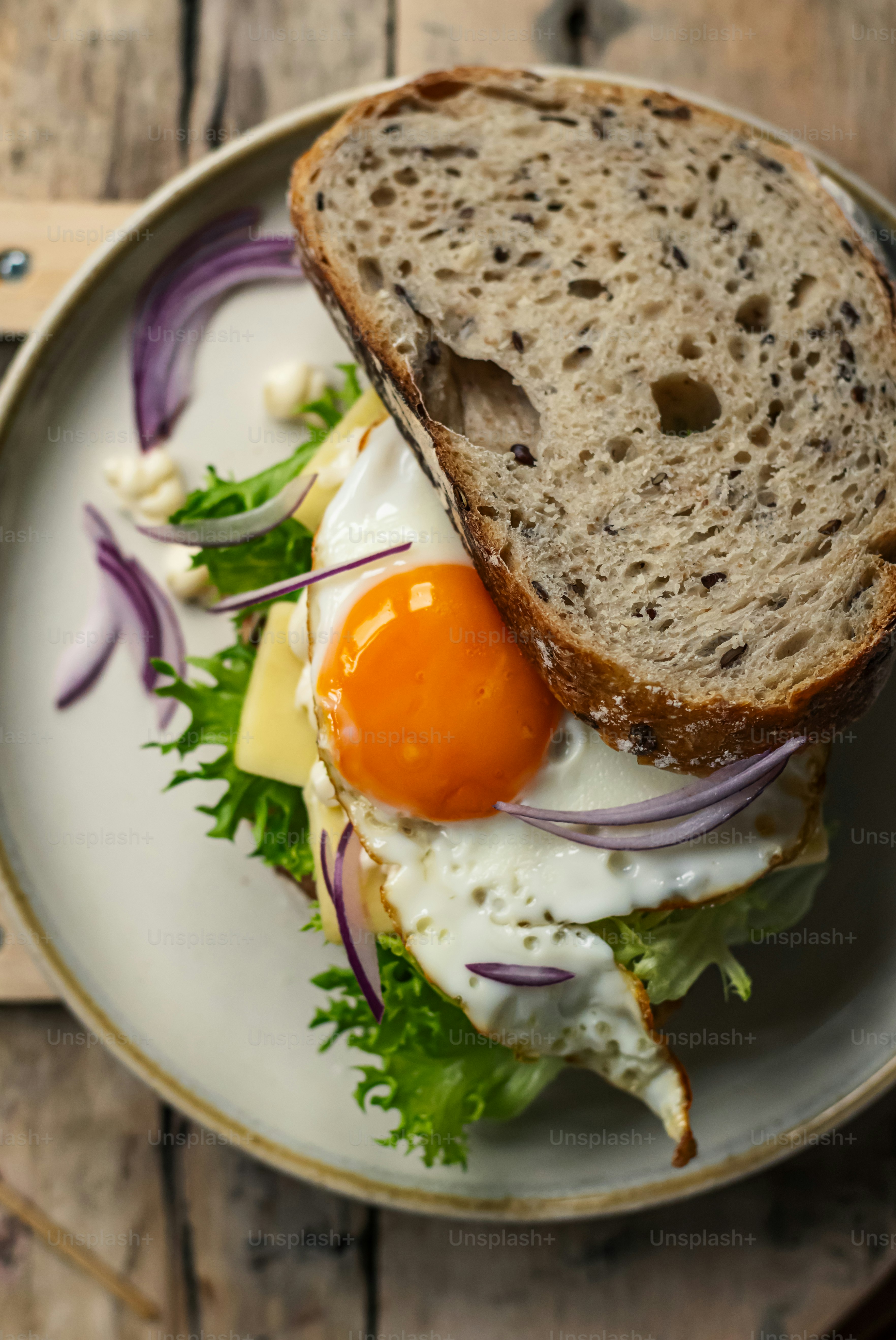 a plate with a sandwich and an egg on it