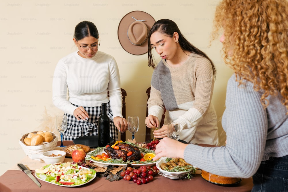 a group of women standing around a table with plates of food