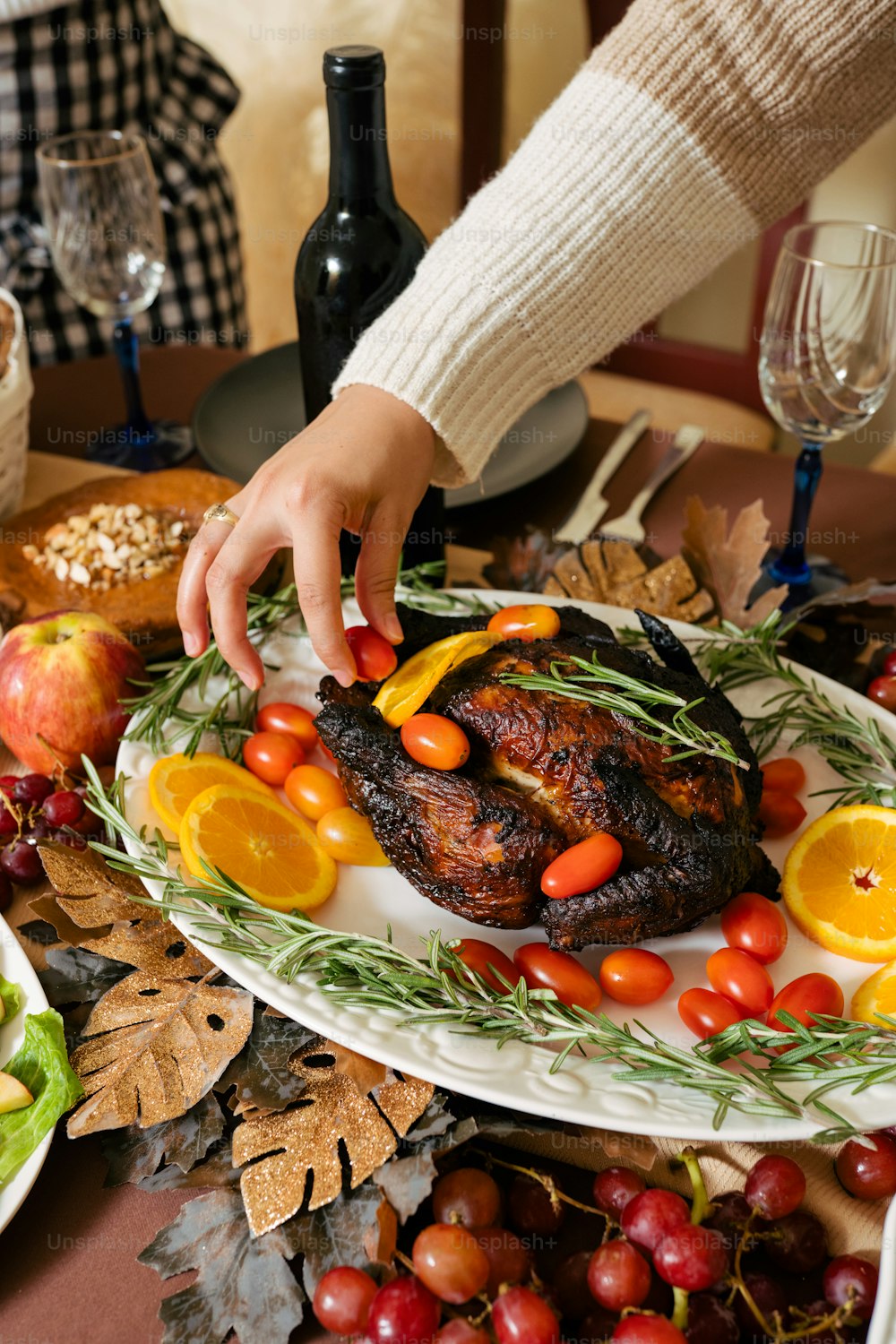 a person placing a piece of meat on a plate