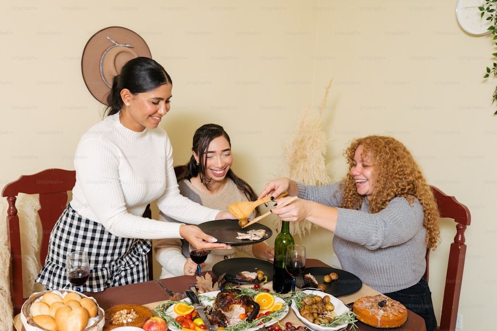 a group of women standing around a table filled with food