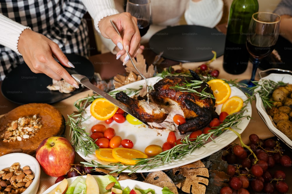 a person cutting a turkey on a platter