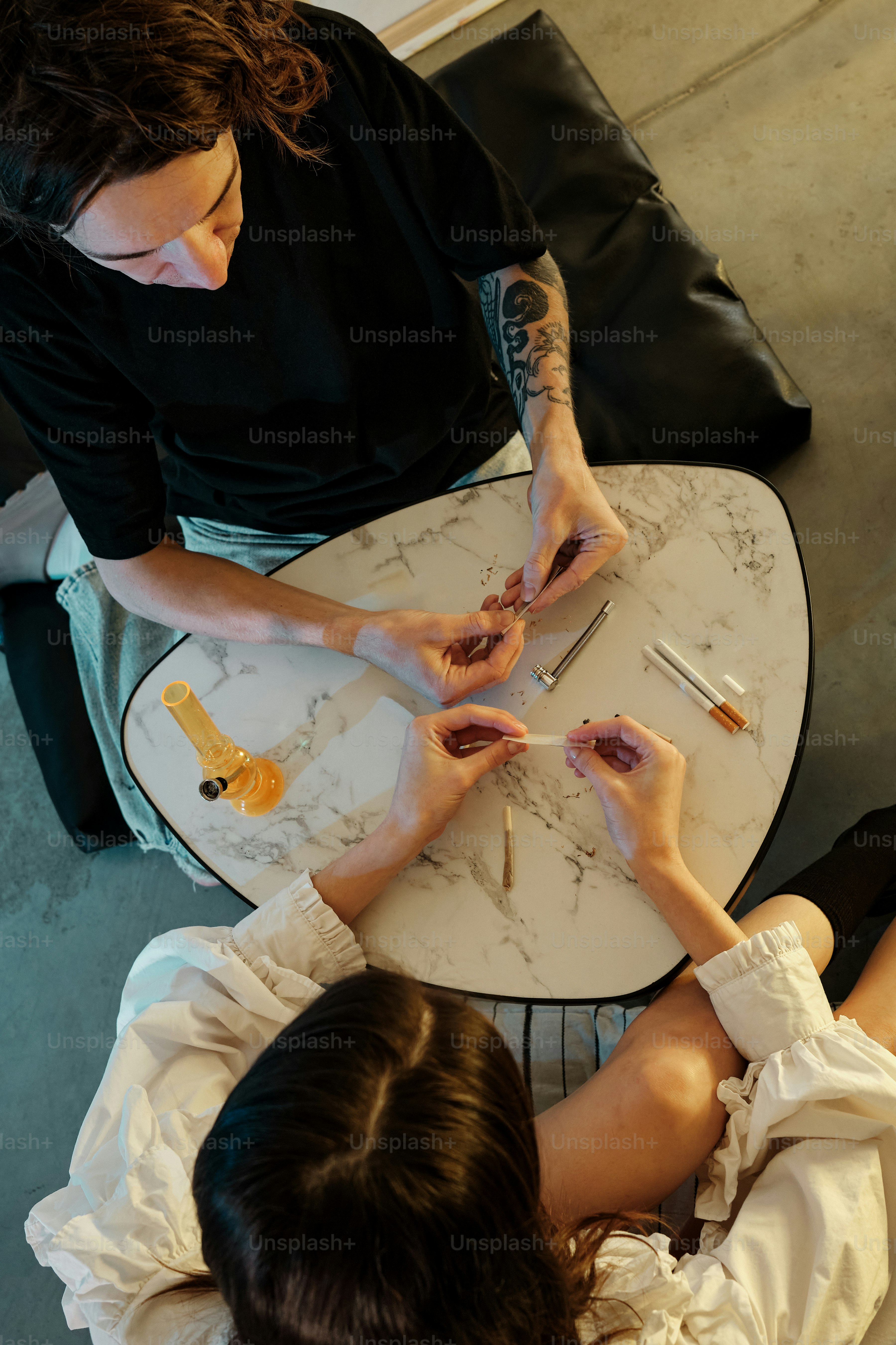 a woman sitting at a table with a knife in her hand