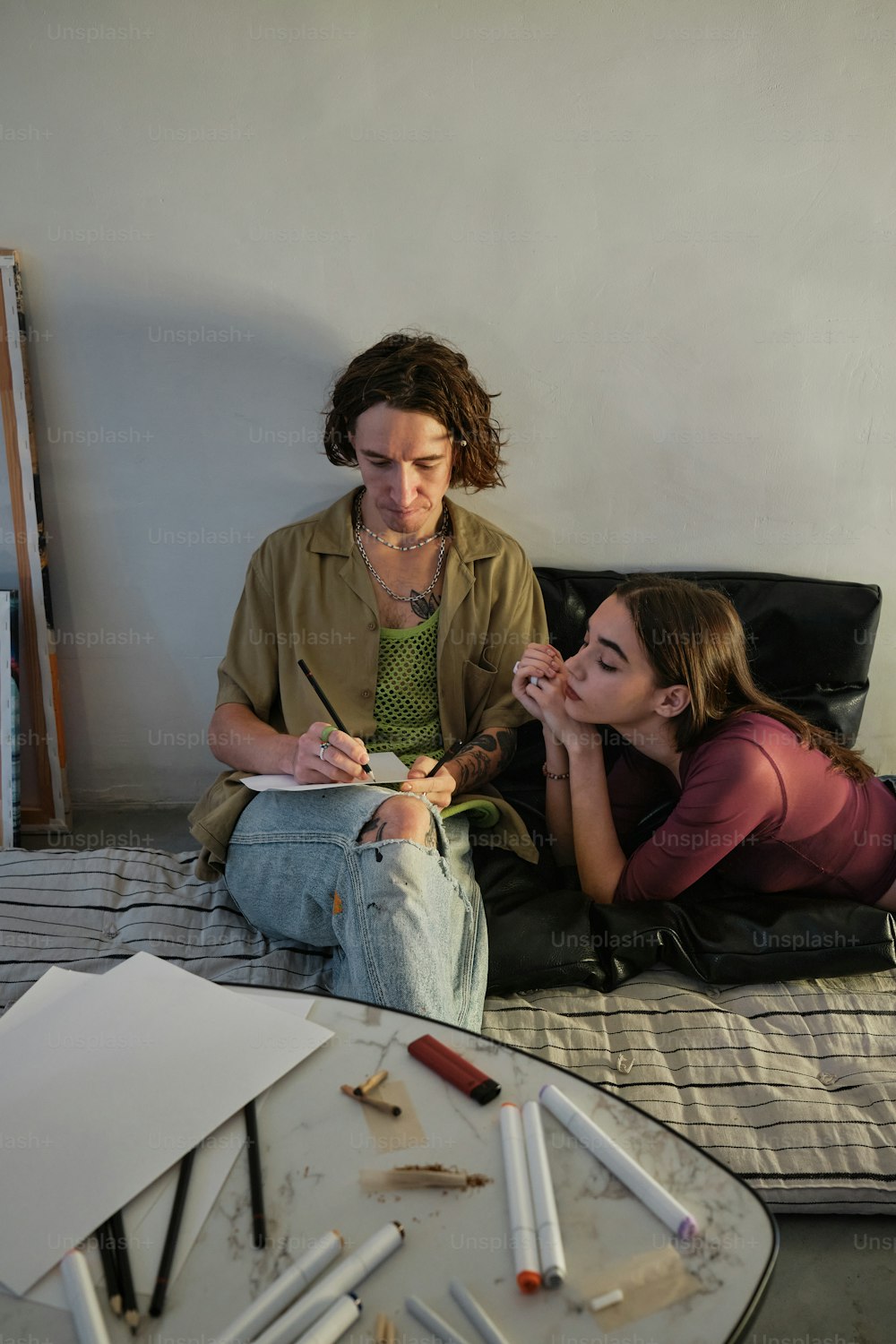 a woman sitting next to a woman on a bed