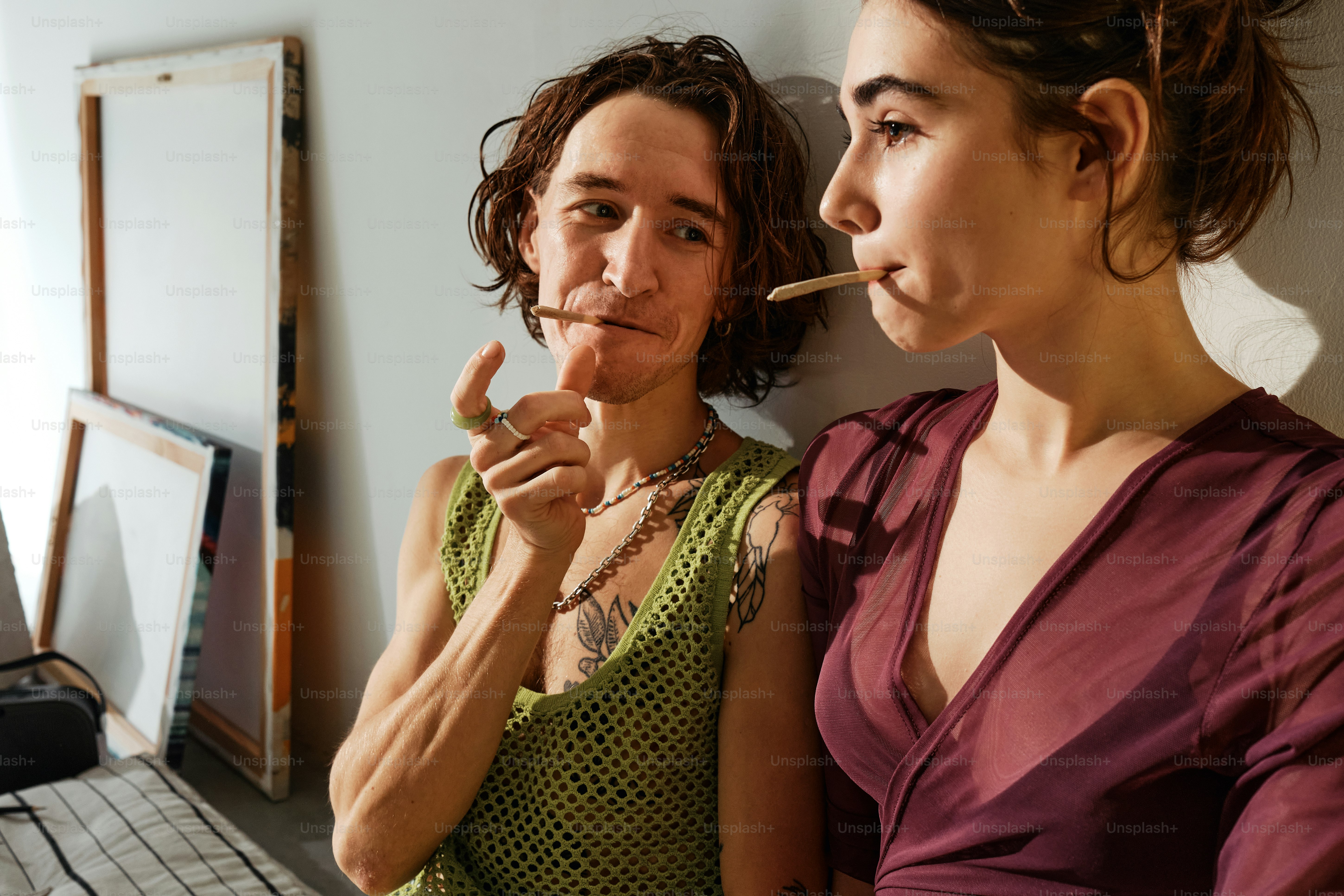 a woman smoking a cigarette next to another woman