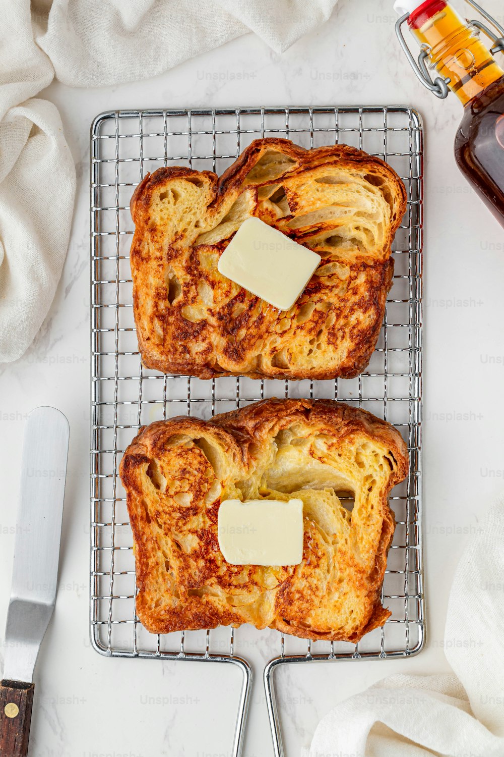 two pieces of bread with cheese on a cooling rack