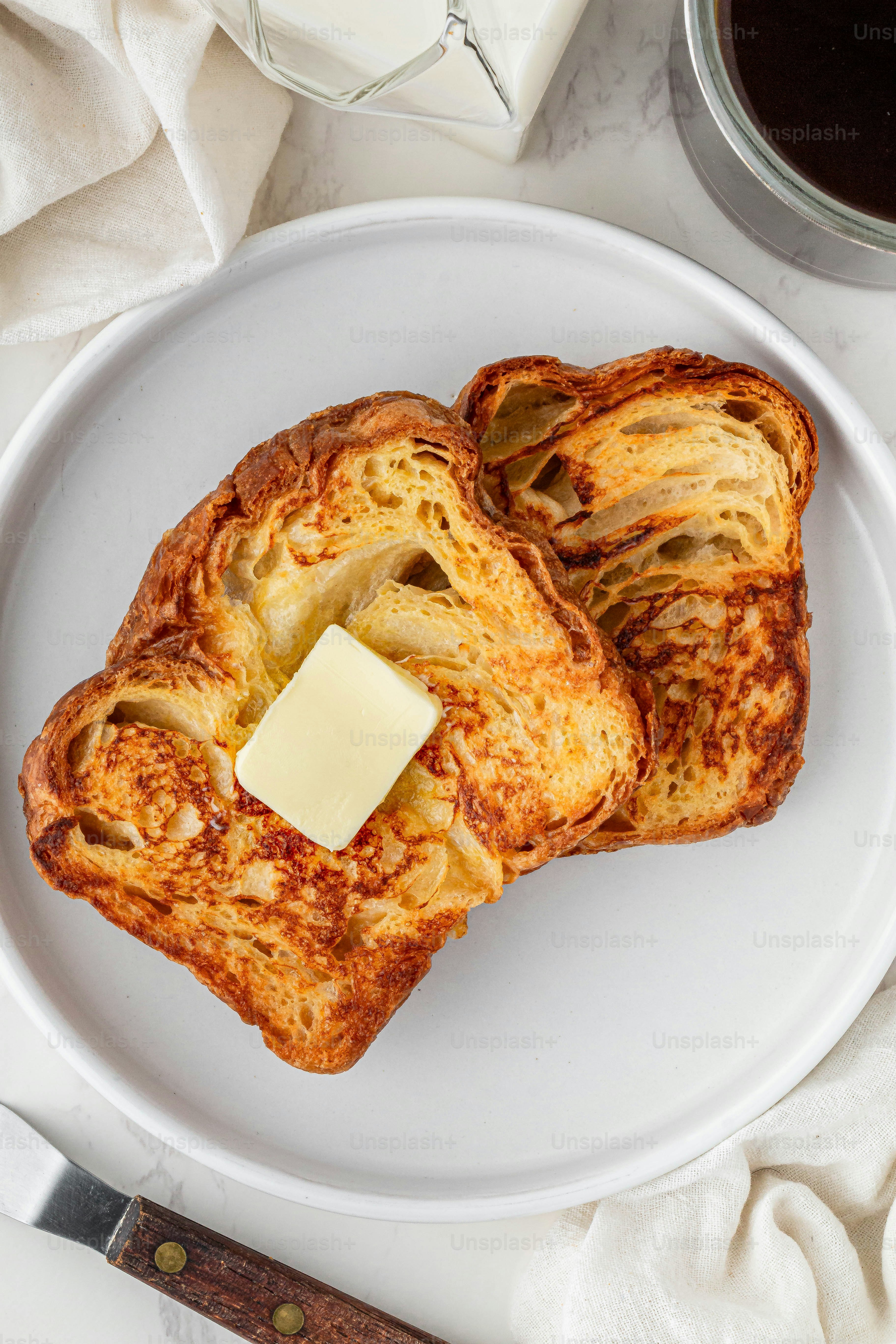 a white plate topped with two pieces of bread