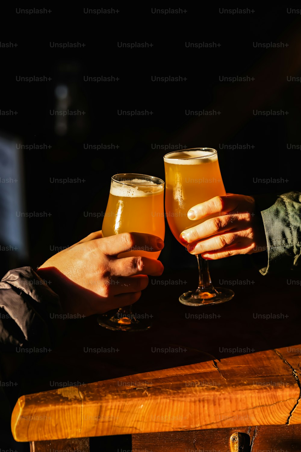a couple of people holding glasses of beer