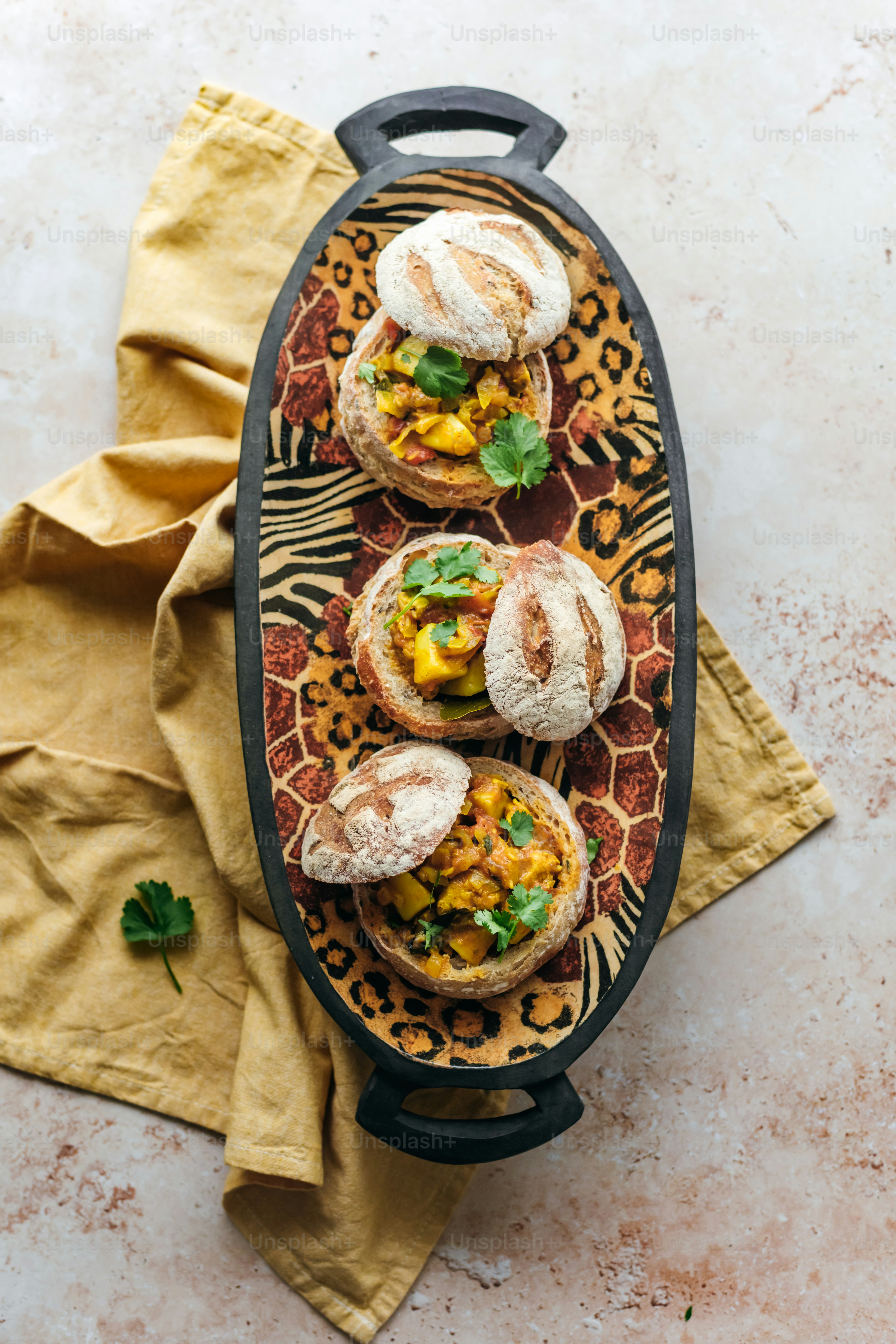 a platter filled with mini sandwiches on top of a table