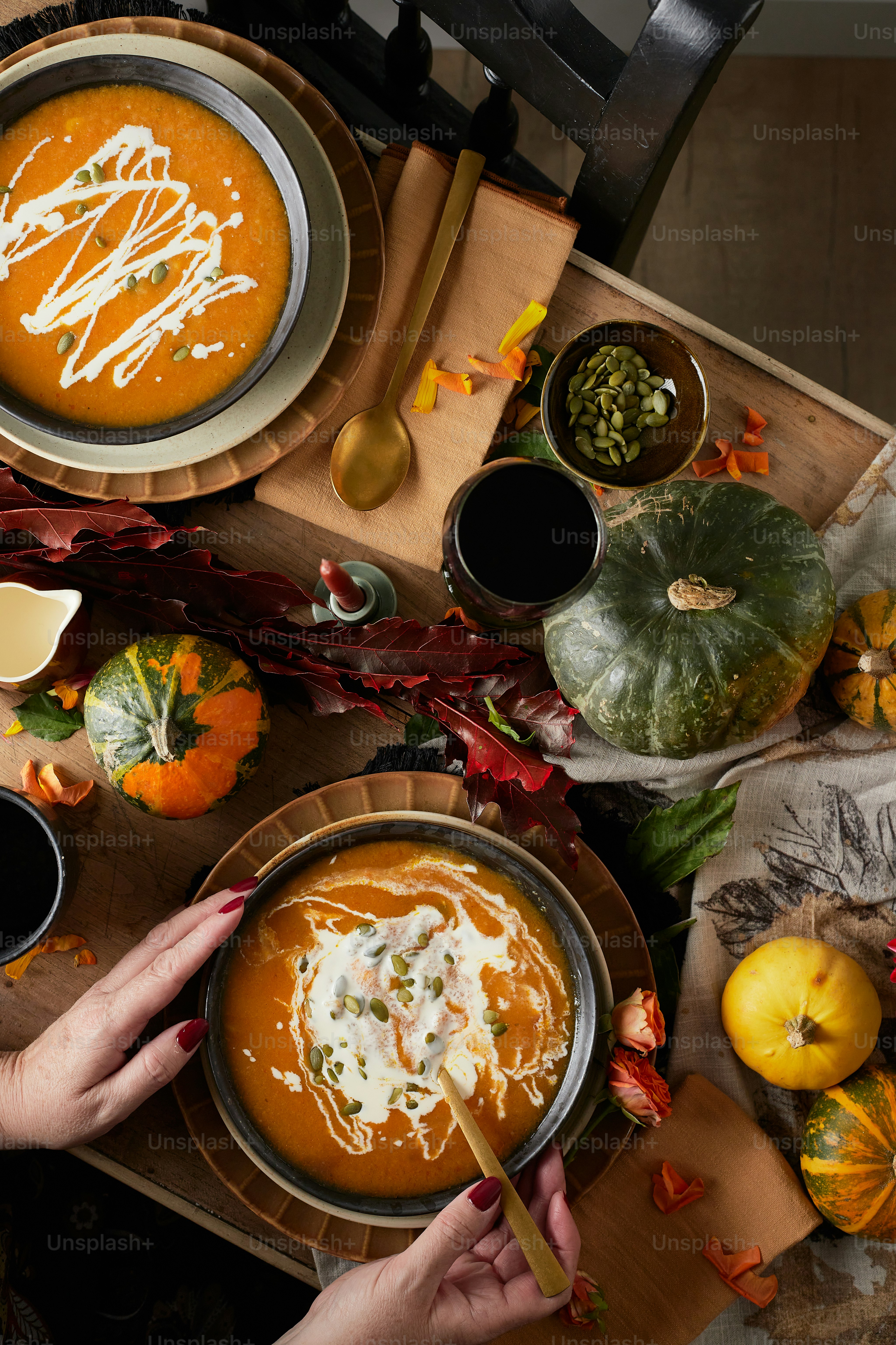 a table topped with bowls of soup and plates of food