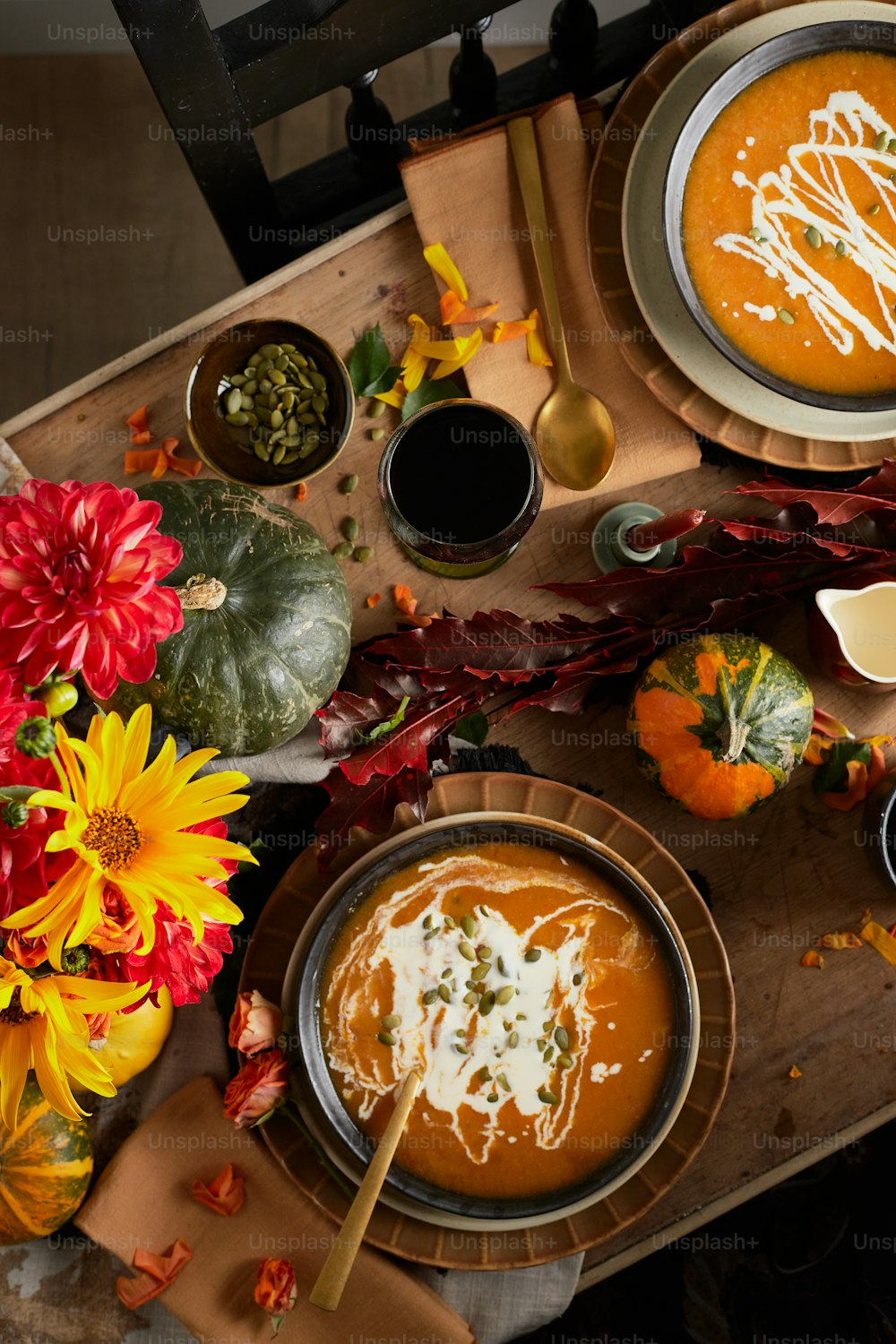 a table topped with bowls of soup and plates of food