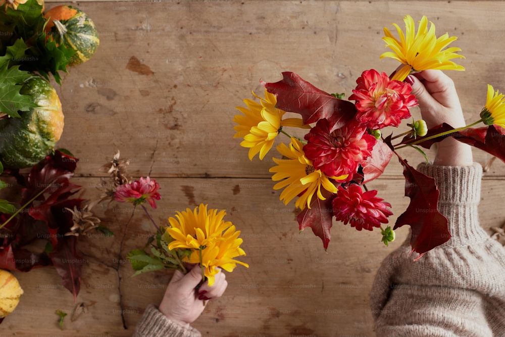 a person holding a bunch of flowers in their hands