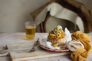 a plate of food and a glass of beer on a table