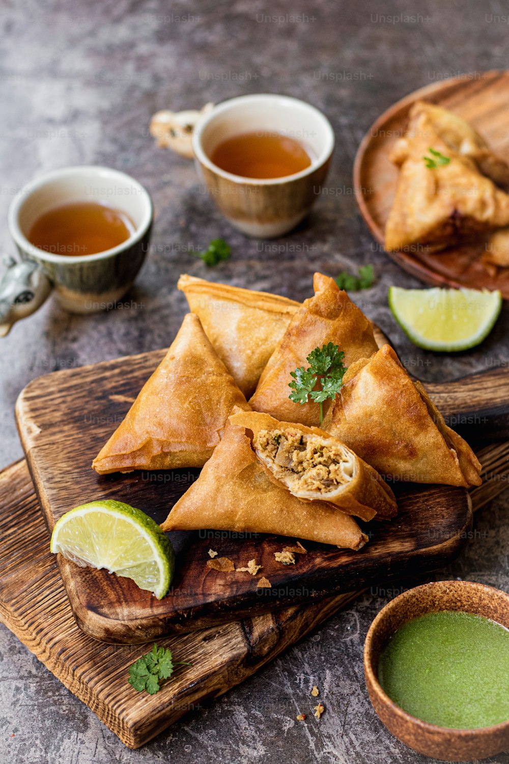 a plate of food on a table with a cup of green tea