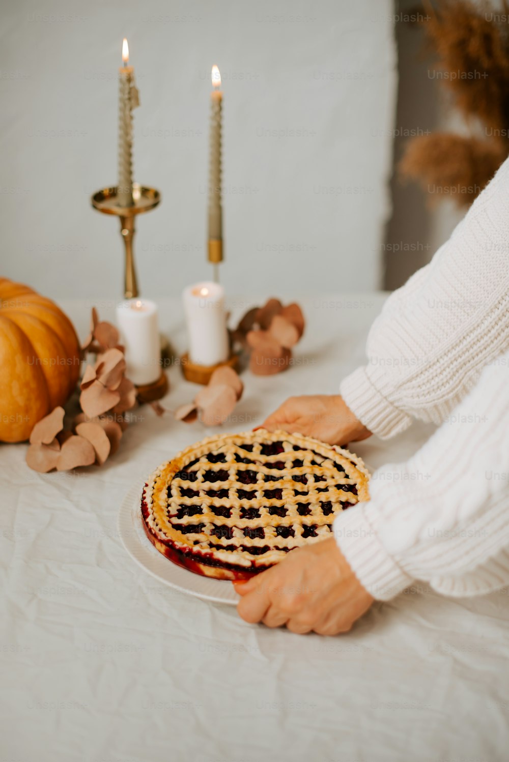 a person putting a pie on a plate