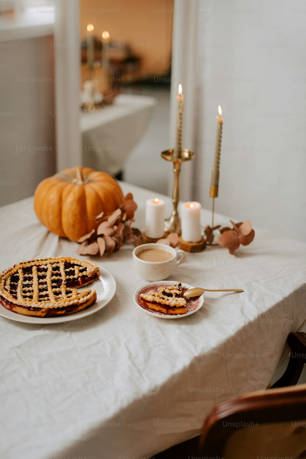 a white table topped with waffles and candles