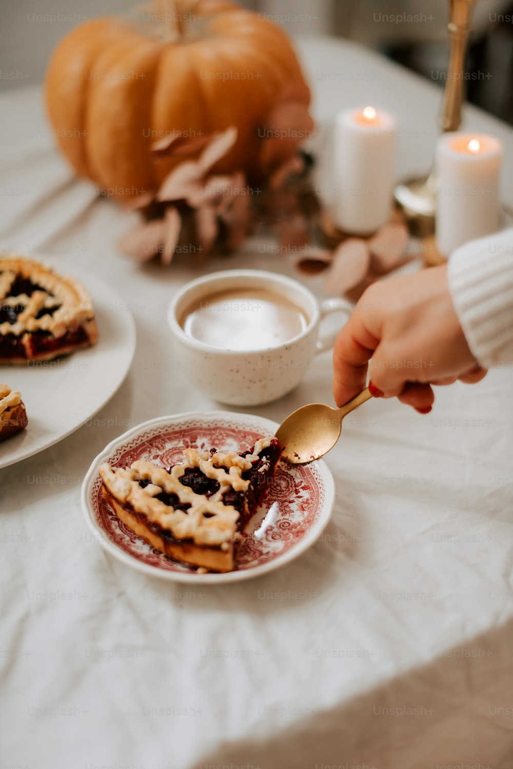 a person holding a spoon over a plate of food