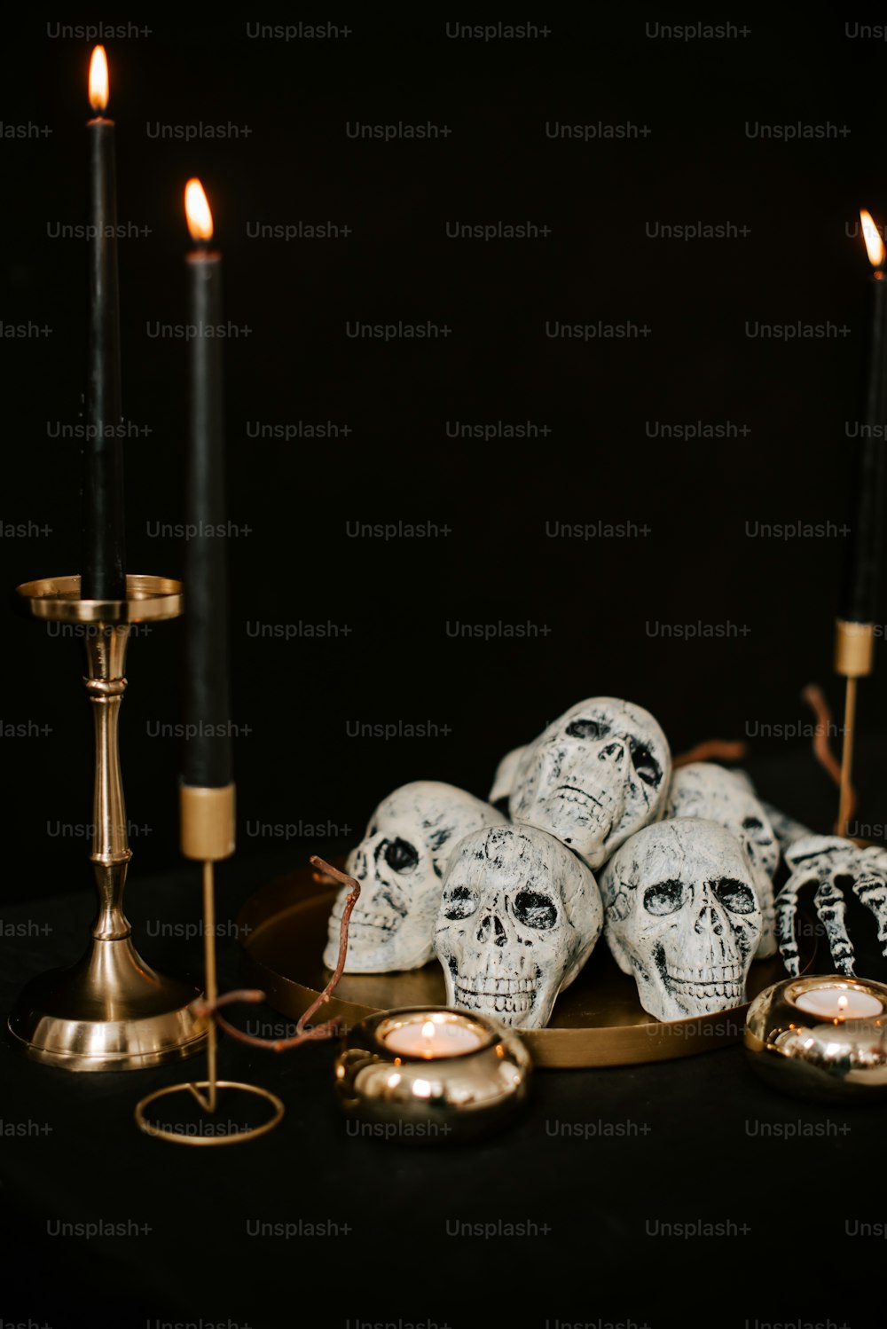 a table topped with skulls and candles