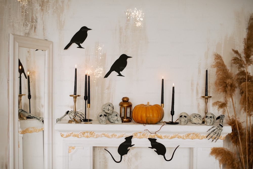 a mantle with candles, a candle holder and a bird on it