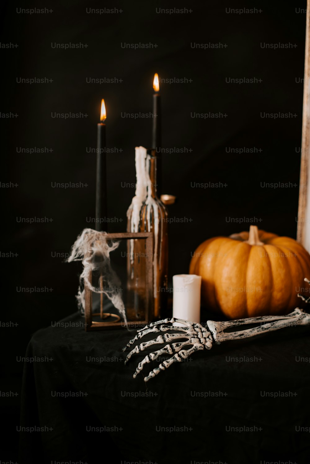 a table topped with candles and a bottle