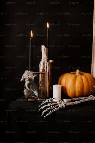 a table topped with candles and a bottle