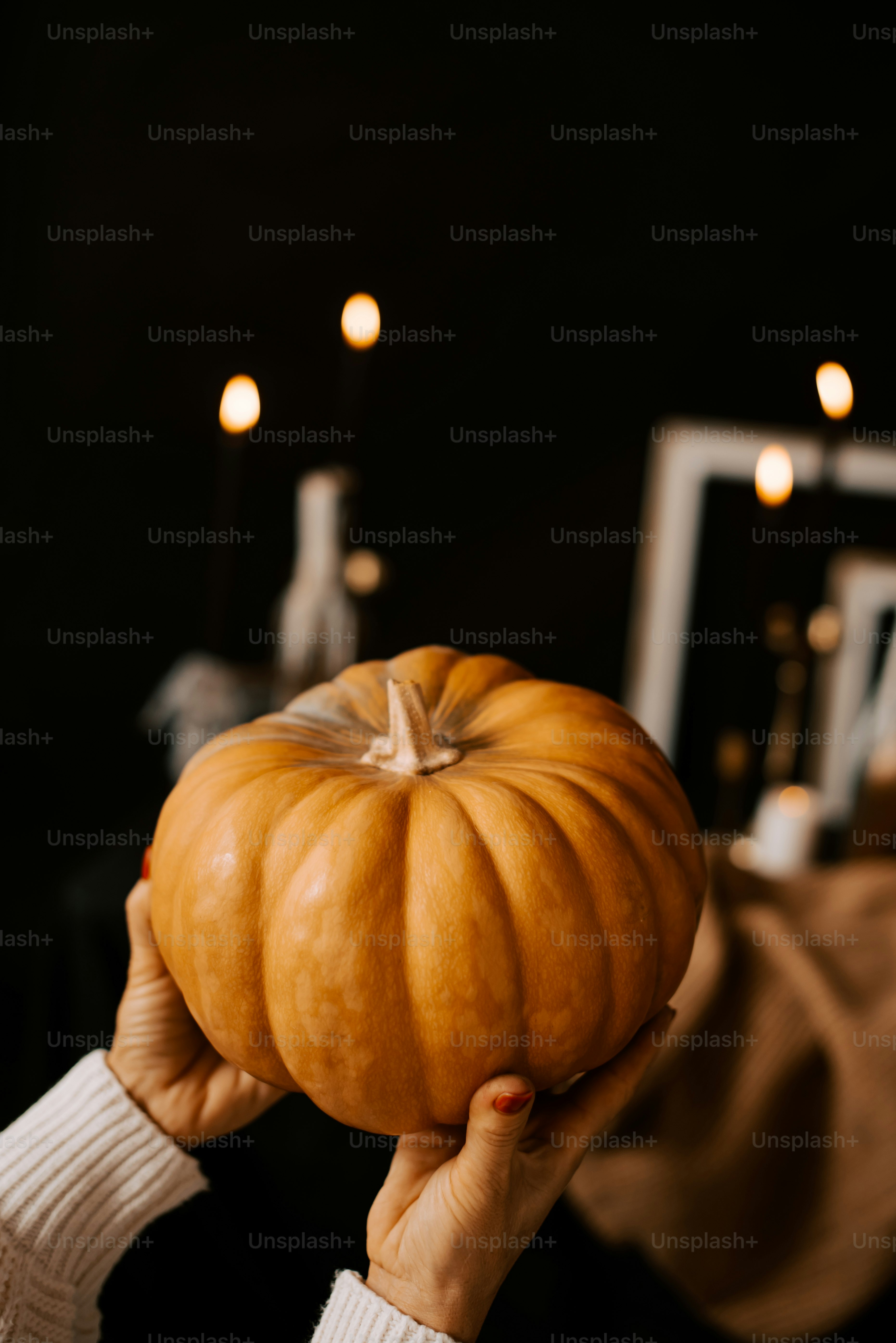 a person holding a pumpkin in their hands