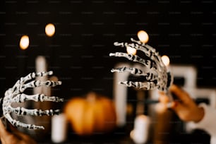 a person holding a fake crown with candles in the background