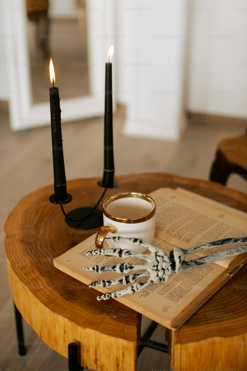 a table topped with a book and two candles