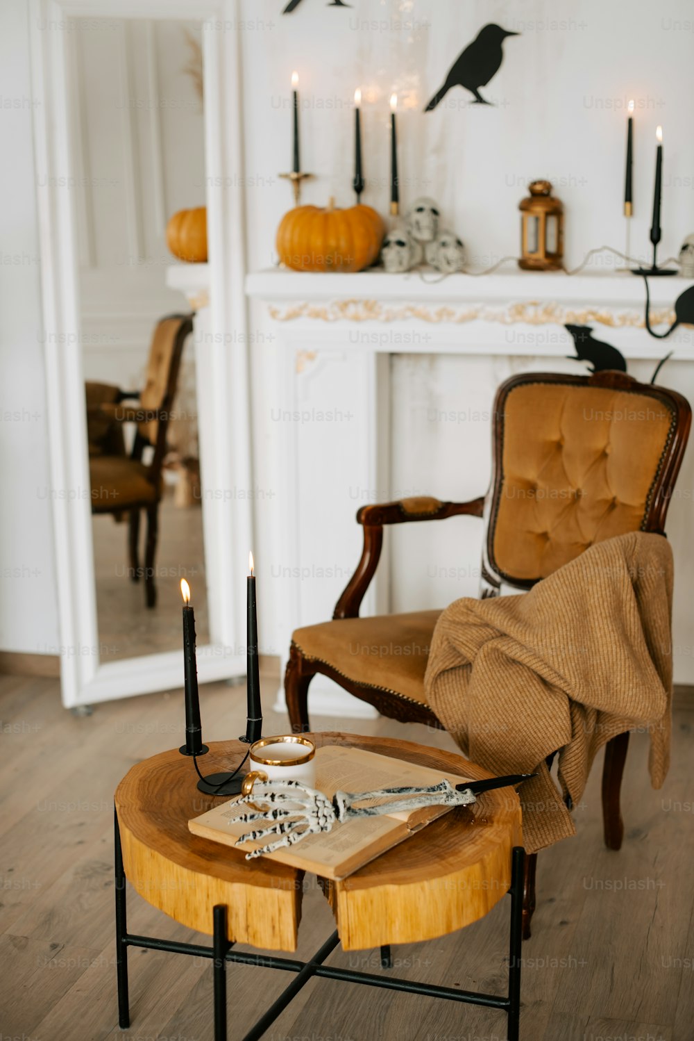 a living room with a chair and a table with candles on it