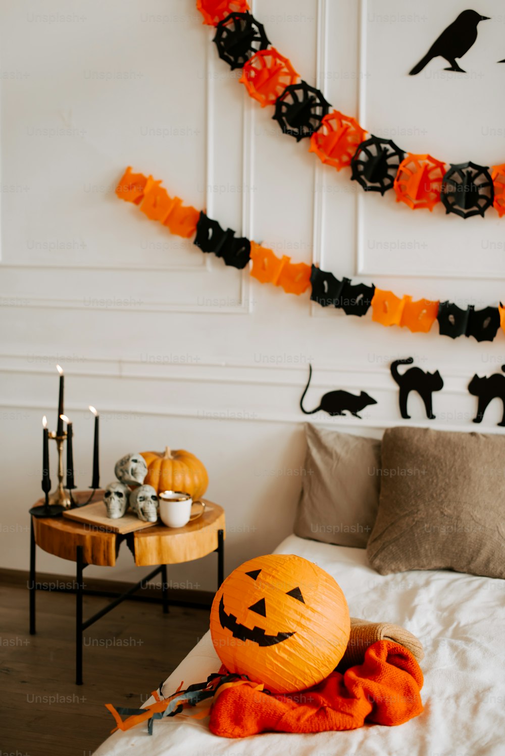 a bedroom decorated for halloween with pumpkins and decorations