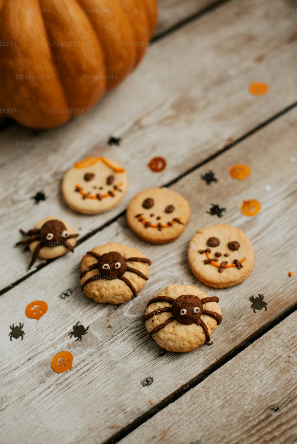 a group of halloween cookies sitting on top of a wooden table