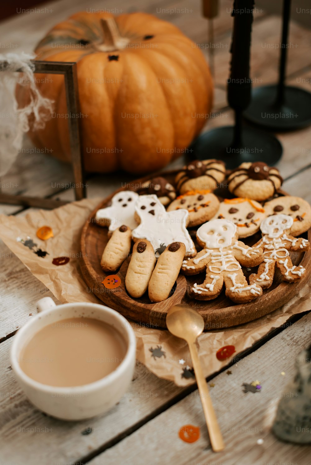 a wooden table topped with cookies and a cup of coffee