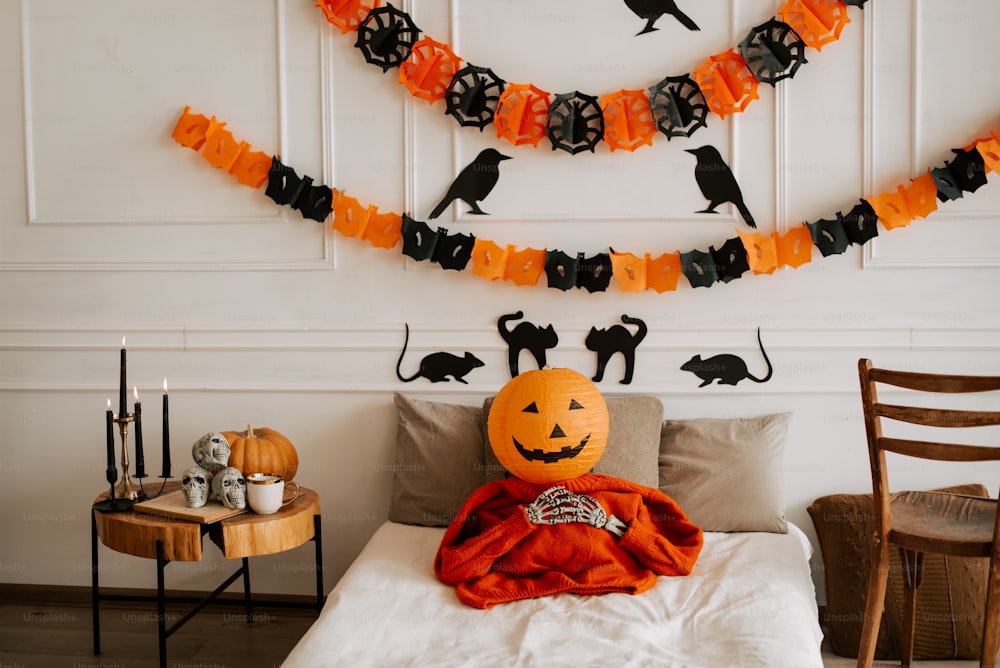 a bedroom decorated for halloween with a bed and decorations