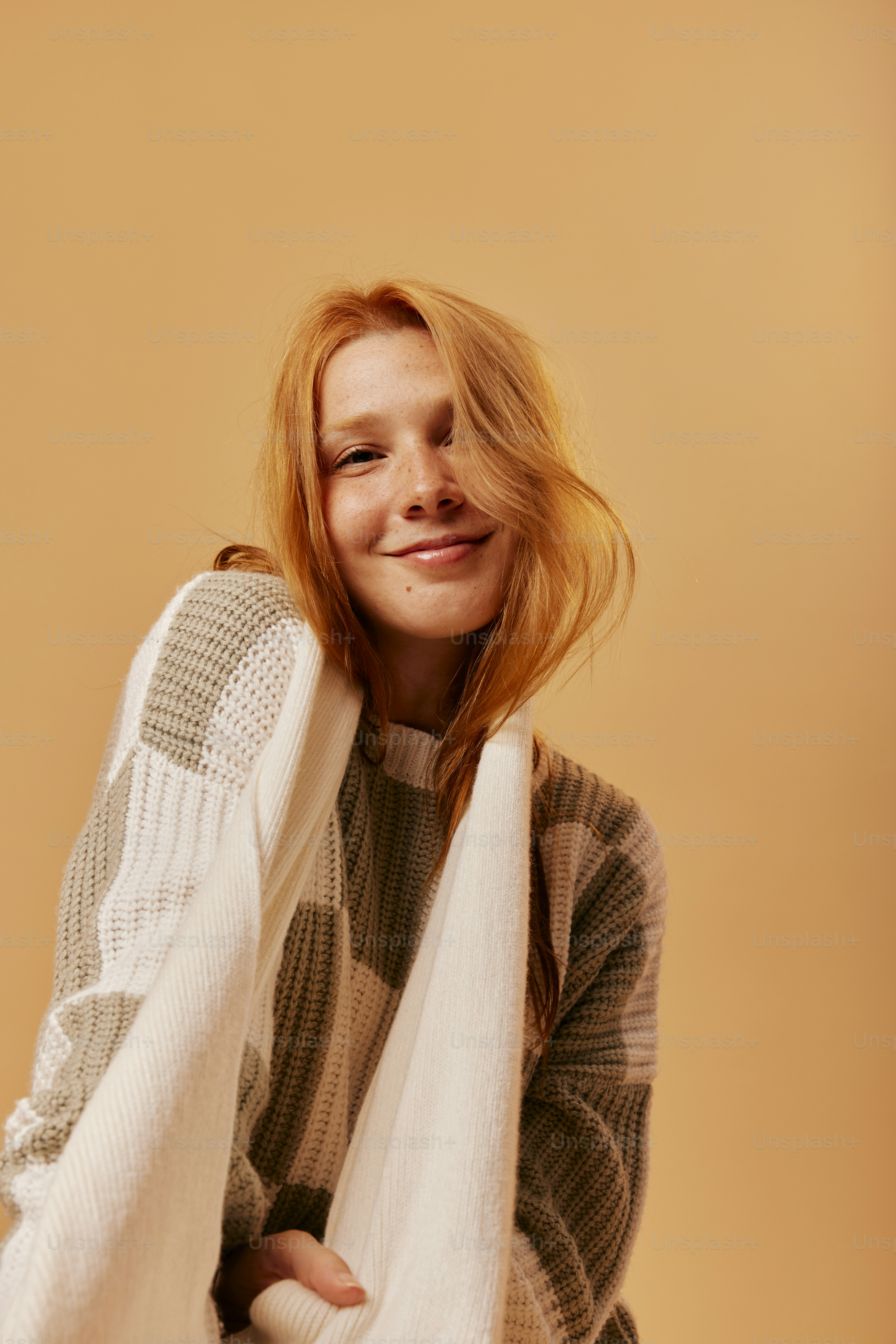 a woman with red hair wearing a white scarf
