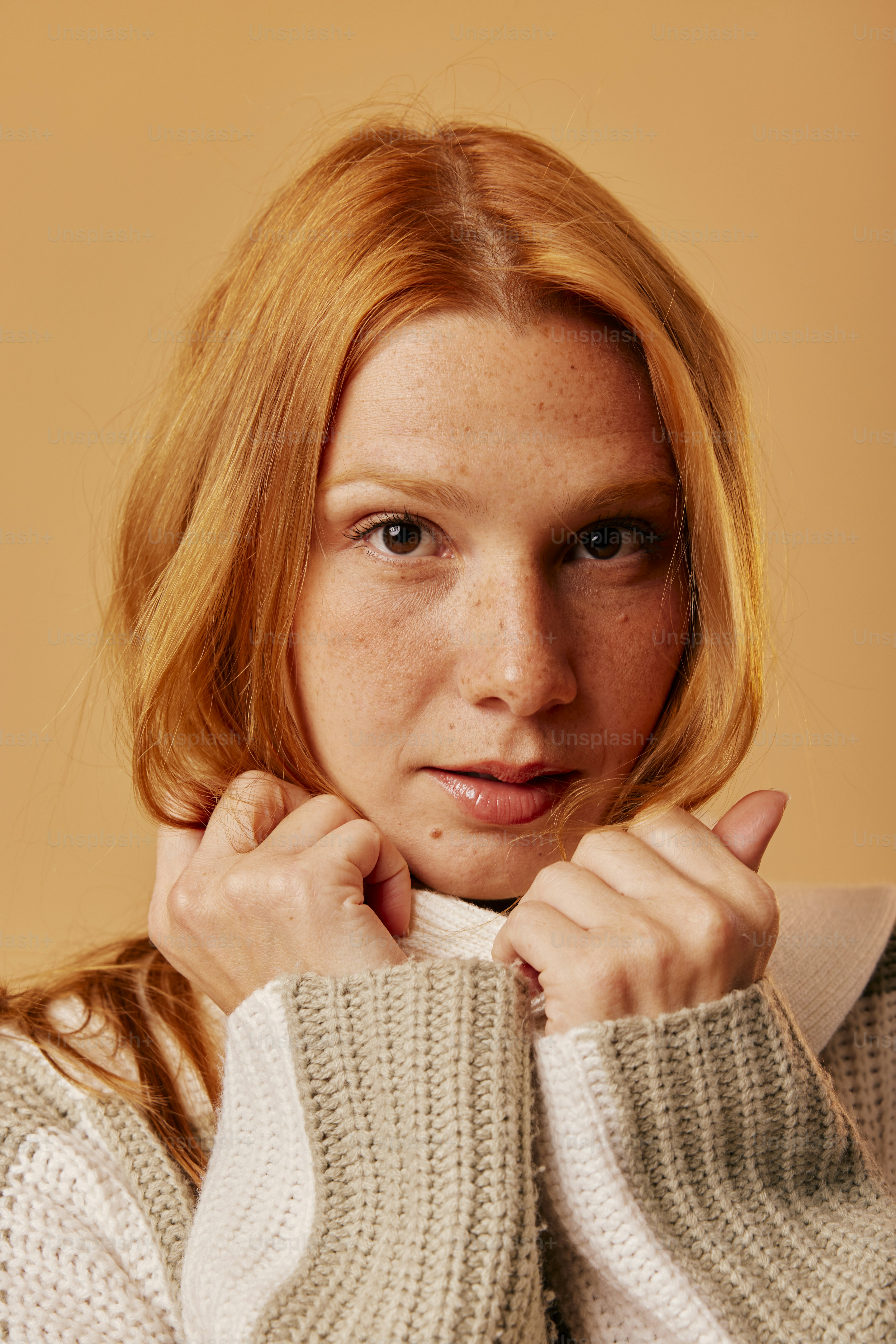 a woman with red hair is posing for a picture