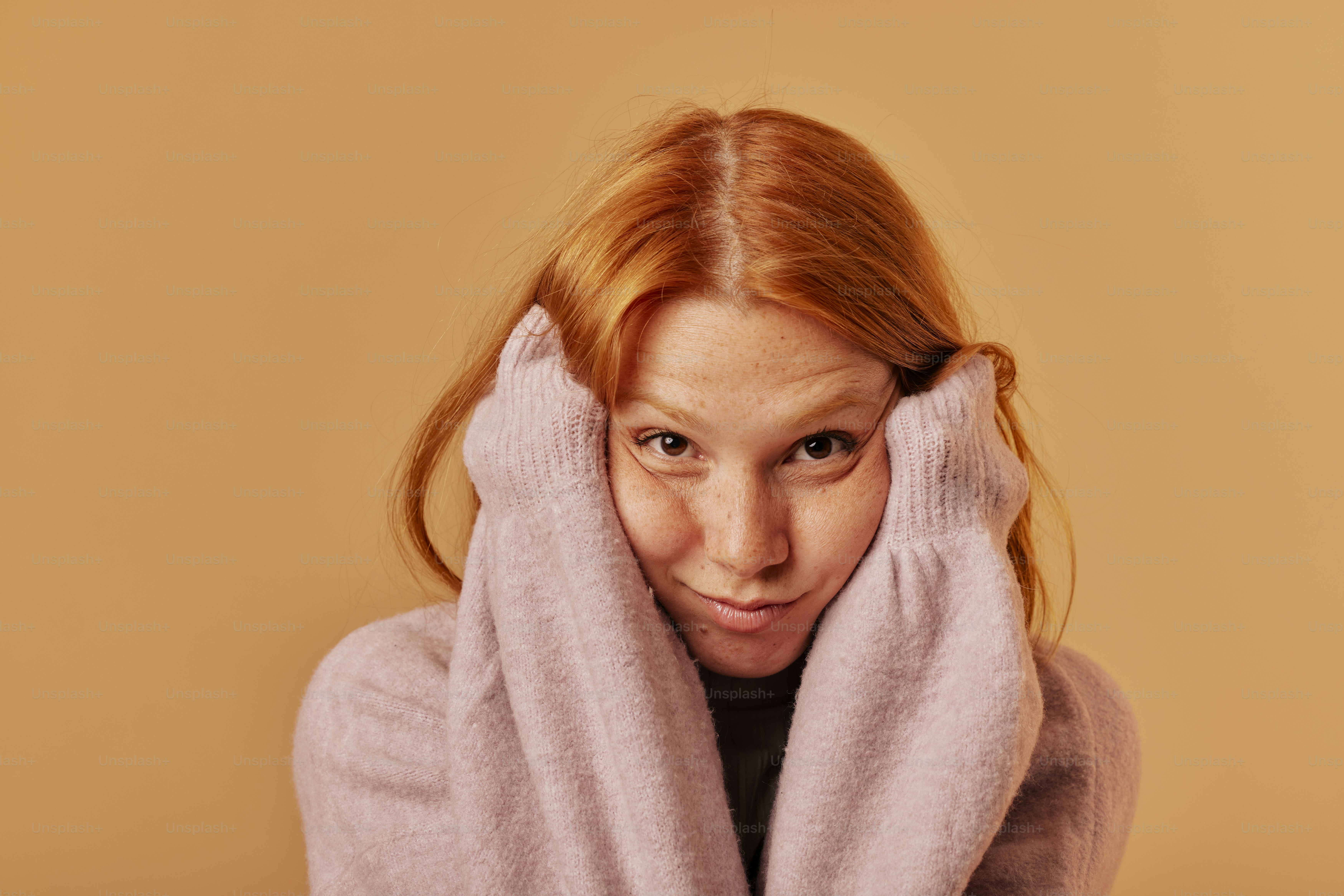 a woman covering her face with a towel