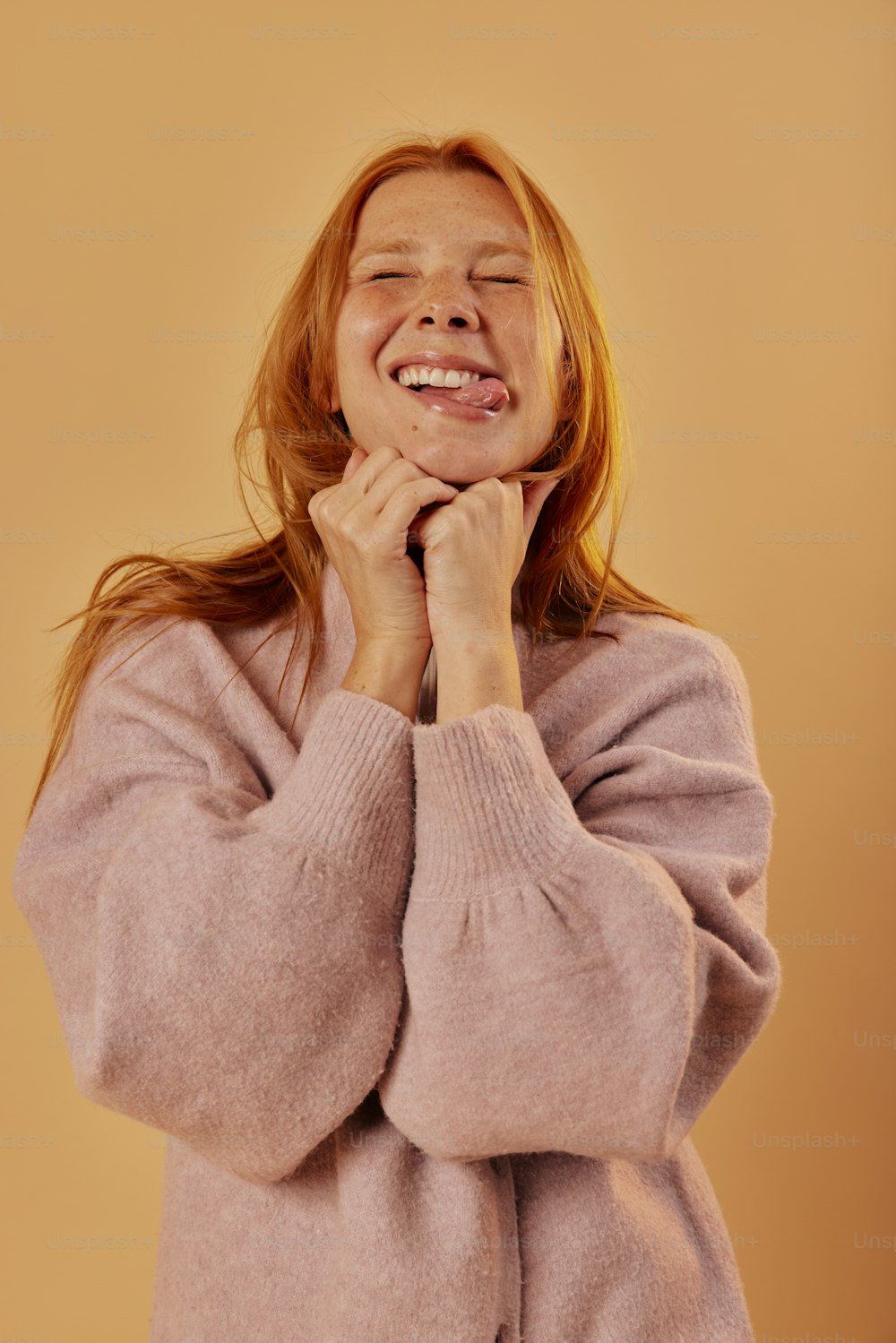 a woman is smiling and holding her hands together