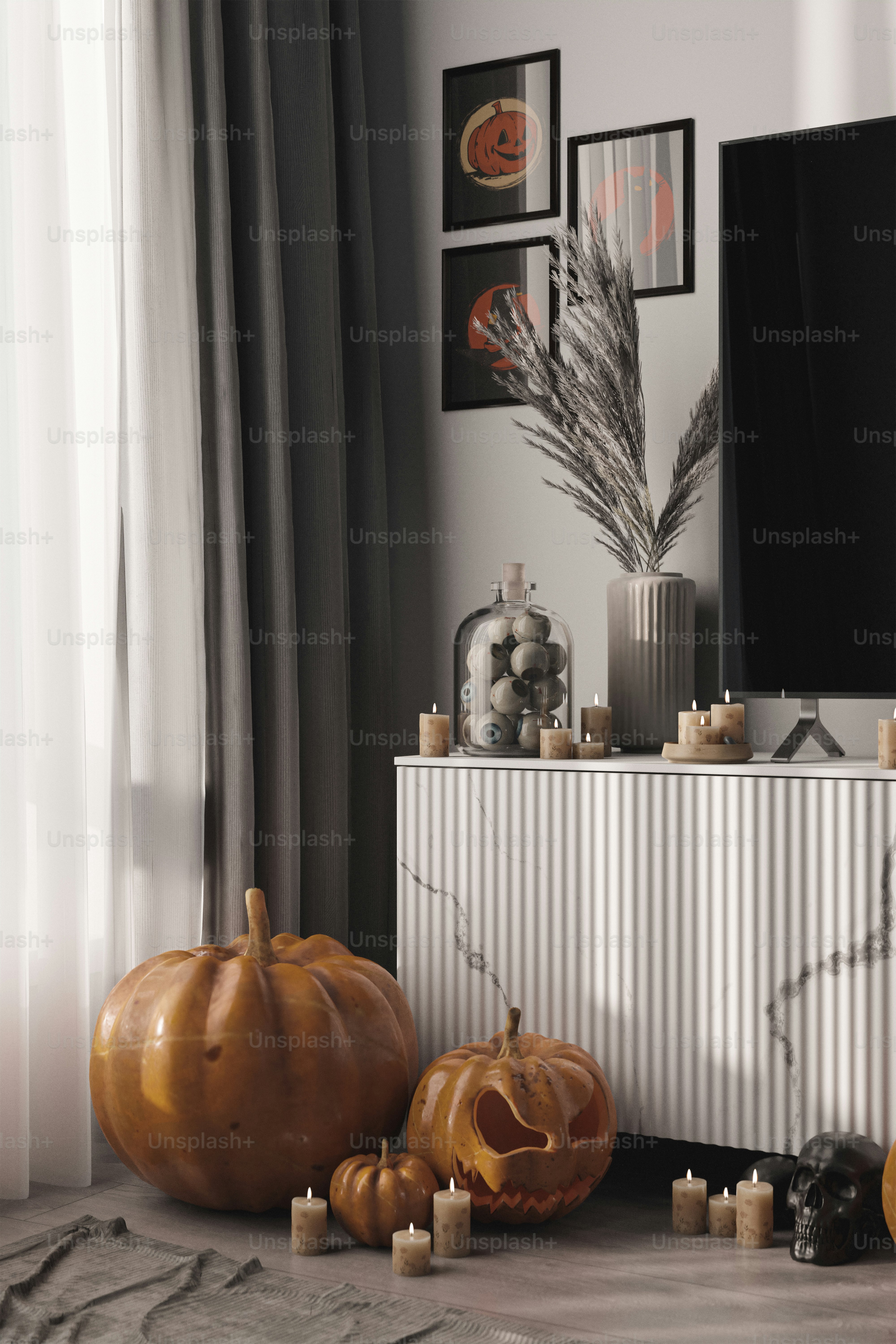 a living room with pumpkins and candles on the floor